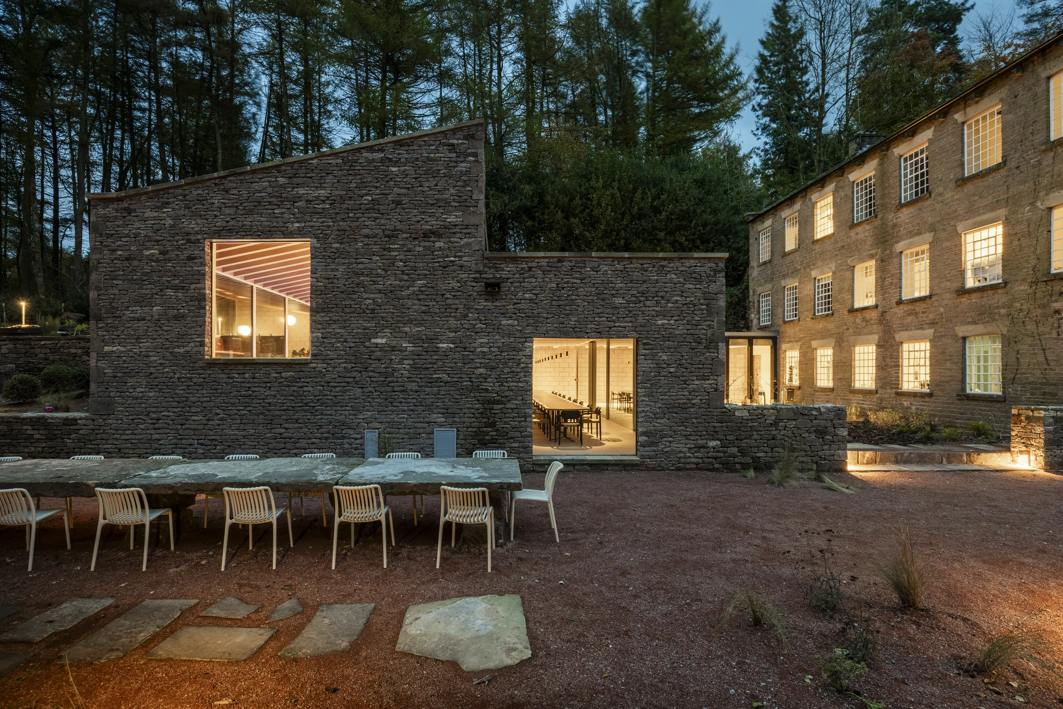 A photo looking in at one of the large dining tables accommodating 40 people available for group stays at ARC Peak District.