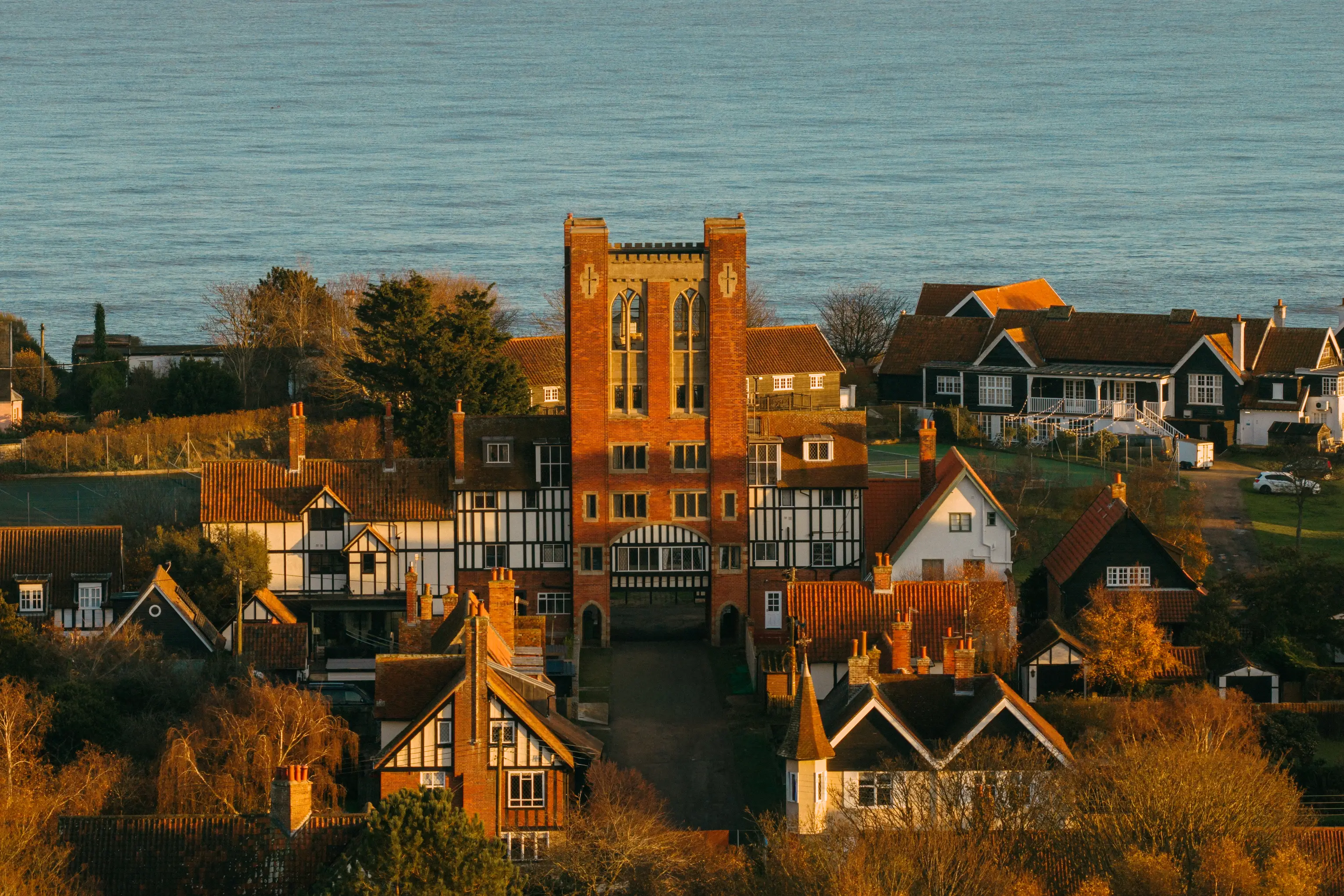 Aerial view of Thorpeness village with the red-brick water tower among the mock-Tudor houses