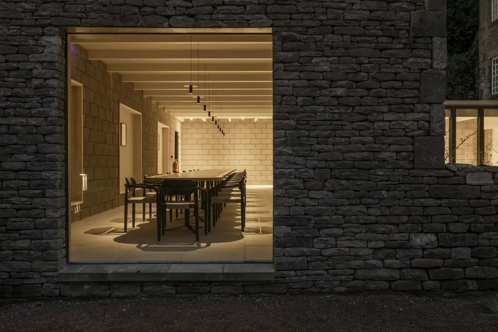 A photo looking in at one of the large dining tables accommodating 40 people available for group stays at ARC Peak District.