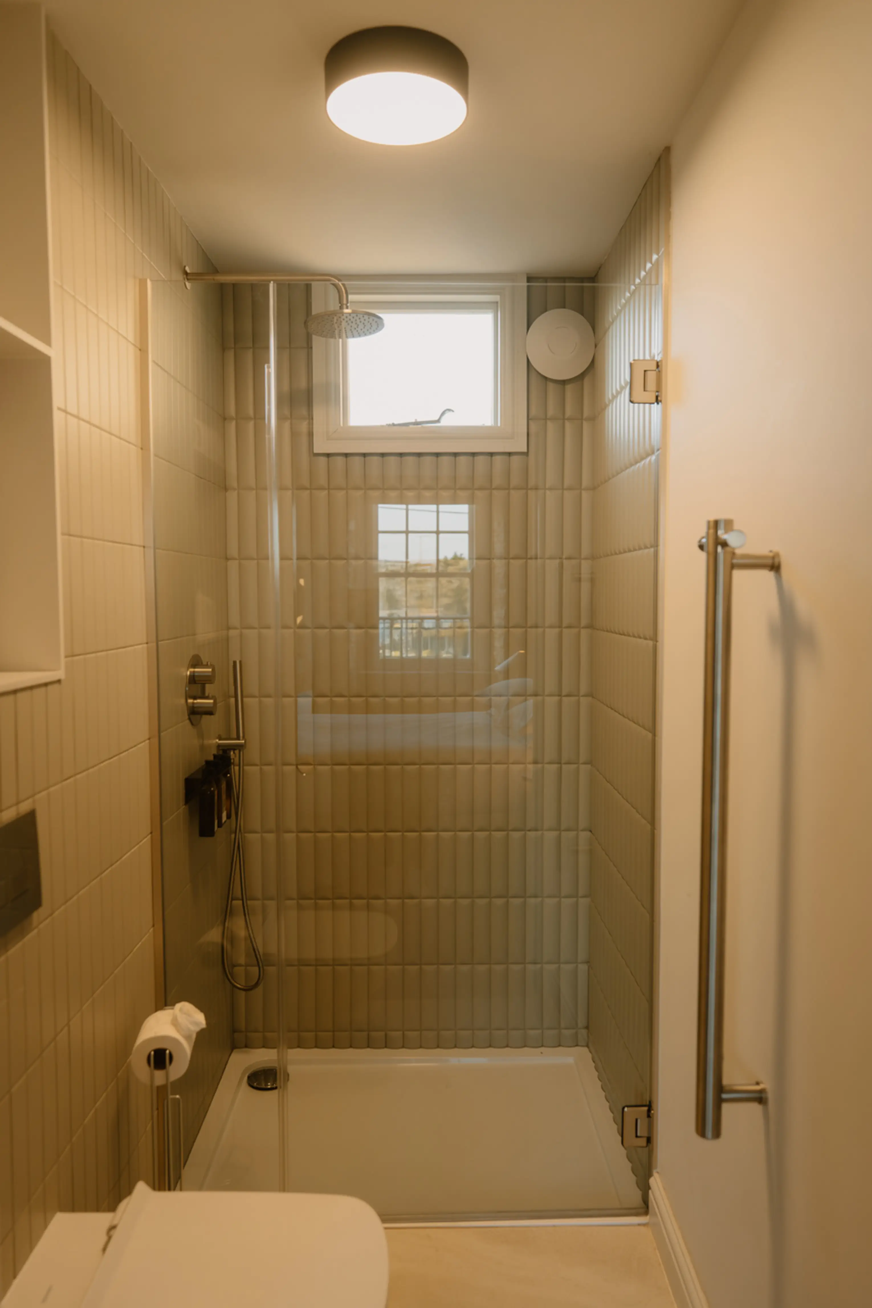 Tiled walk-in shower with a glass screen at ARC Padstow