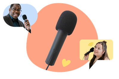 A woman and a man holding the KRUU microphone for the audio guestbook