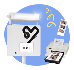 A modern white KRUU Photo Booth against a blue circular background. To the right are printed photo strips and a compact white Selphy printer with printed photos in its tray. A yellow squiggle graphic floats above.
