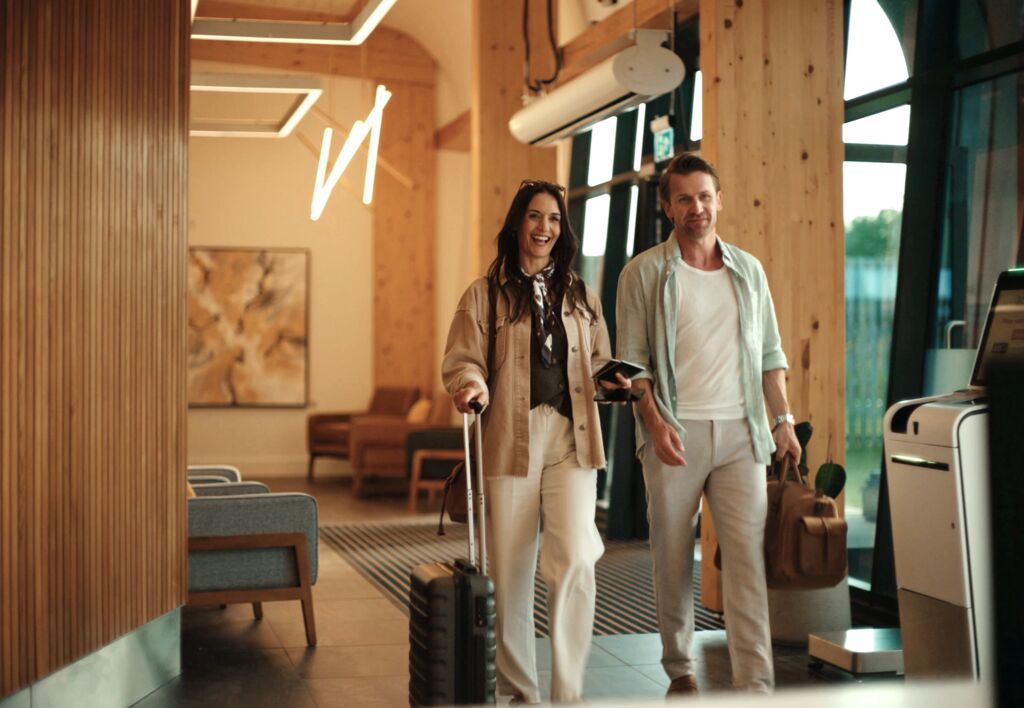 a couple walking through aether Manchester Airport