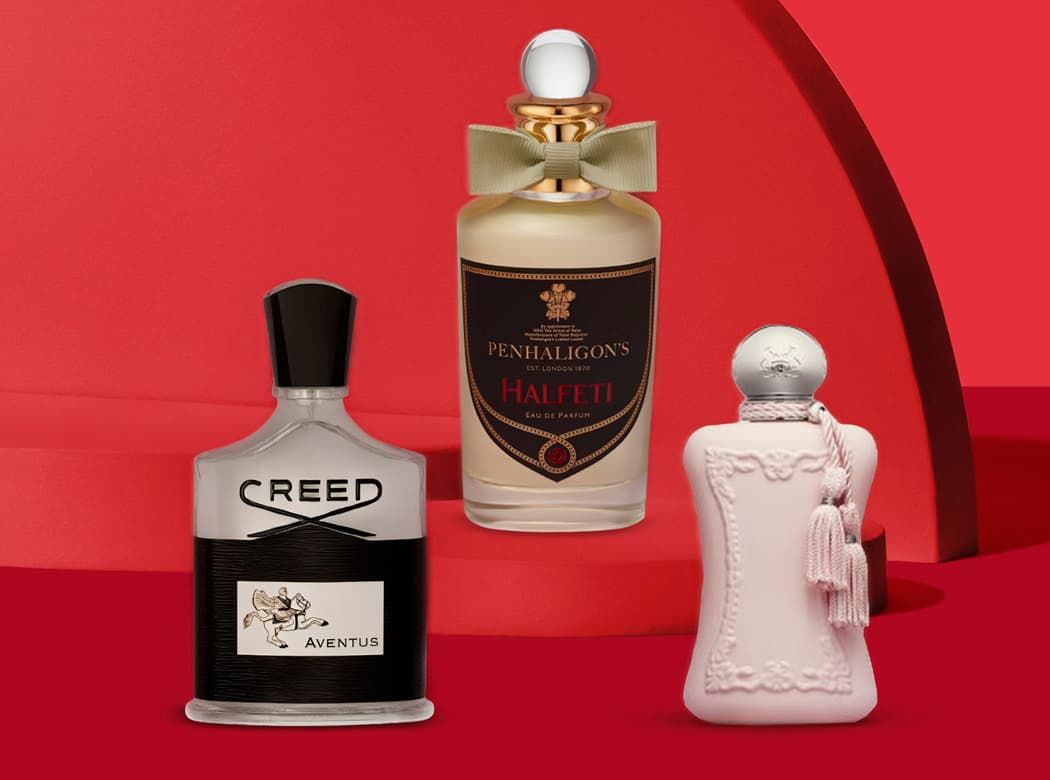 Three perfume bottles are arranged against a red background: Creed Aventus, Penhaligon's Halfeti, and a pink ornate bottle.
