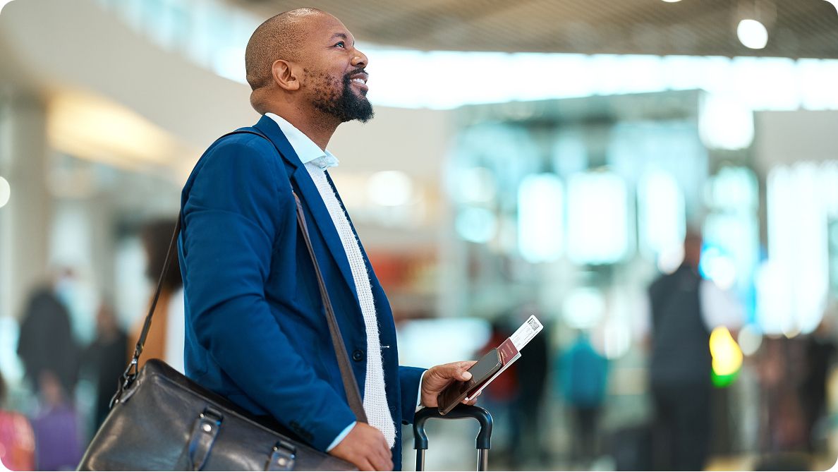 Man smiling holding passport
