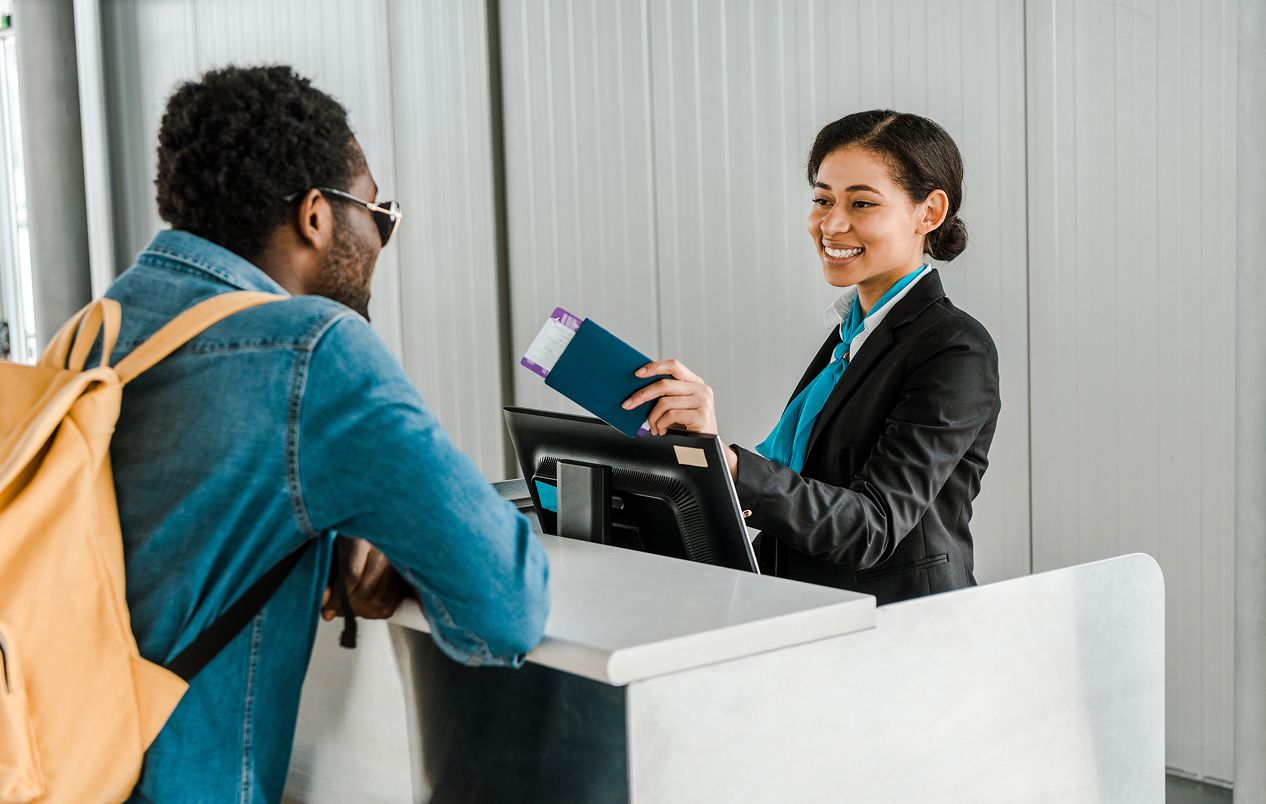 people at airport check in desk