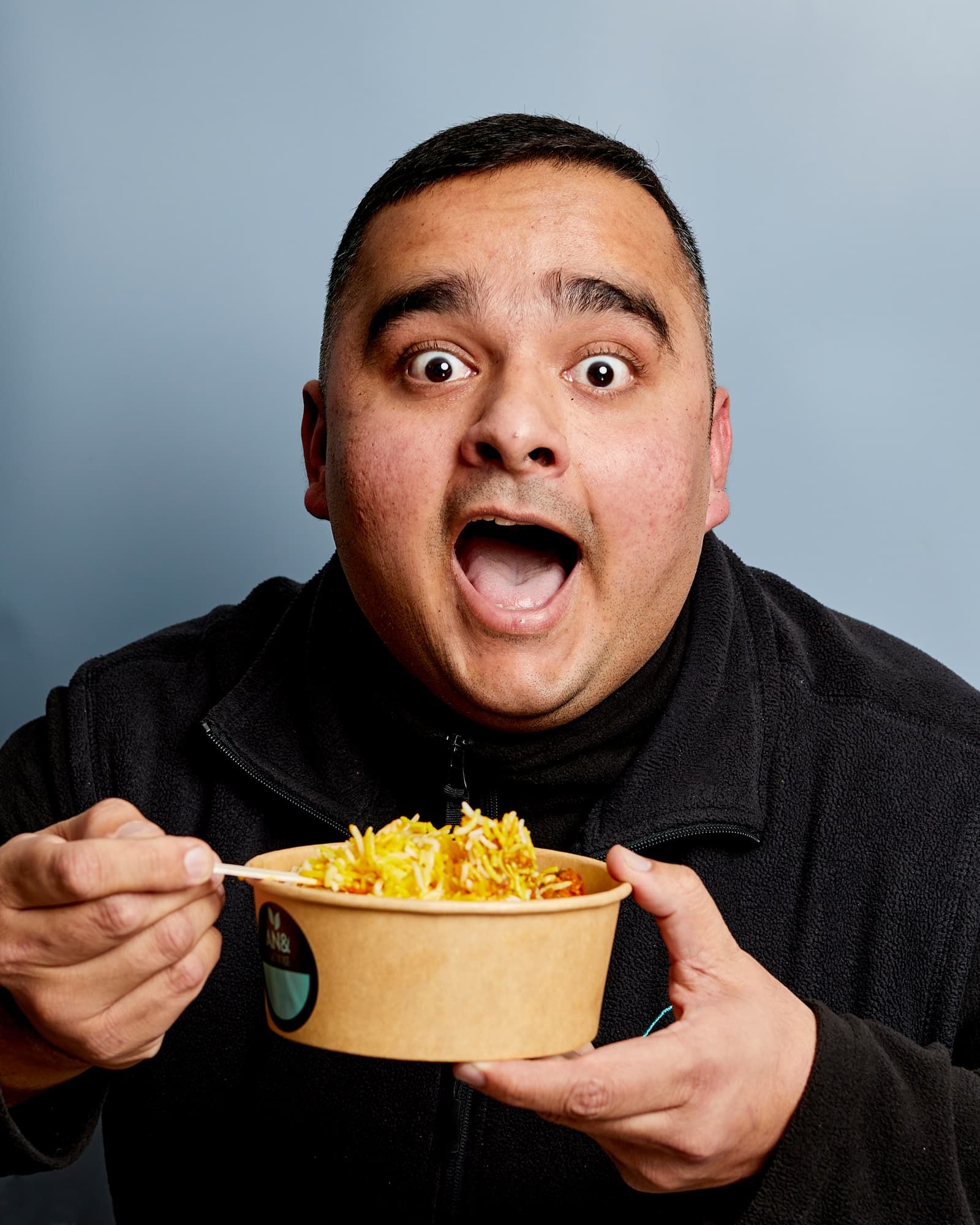 Man looking shocked eating food