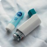 Inhaler and lip balm on bed