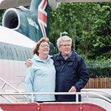 Couple standing outside of plane
