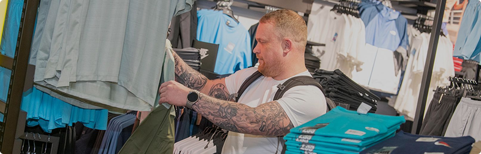 Man looking at clothes in shop