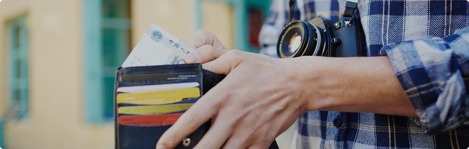 Man putting cash into wallet