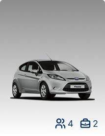 Small silver car that holds 4 passengers and 2 suitcases