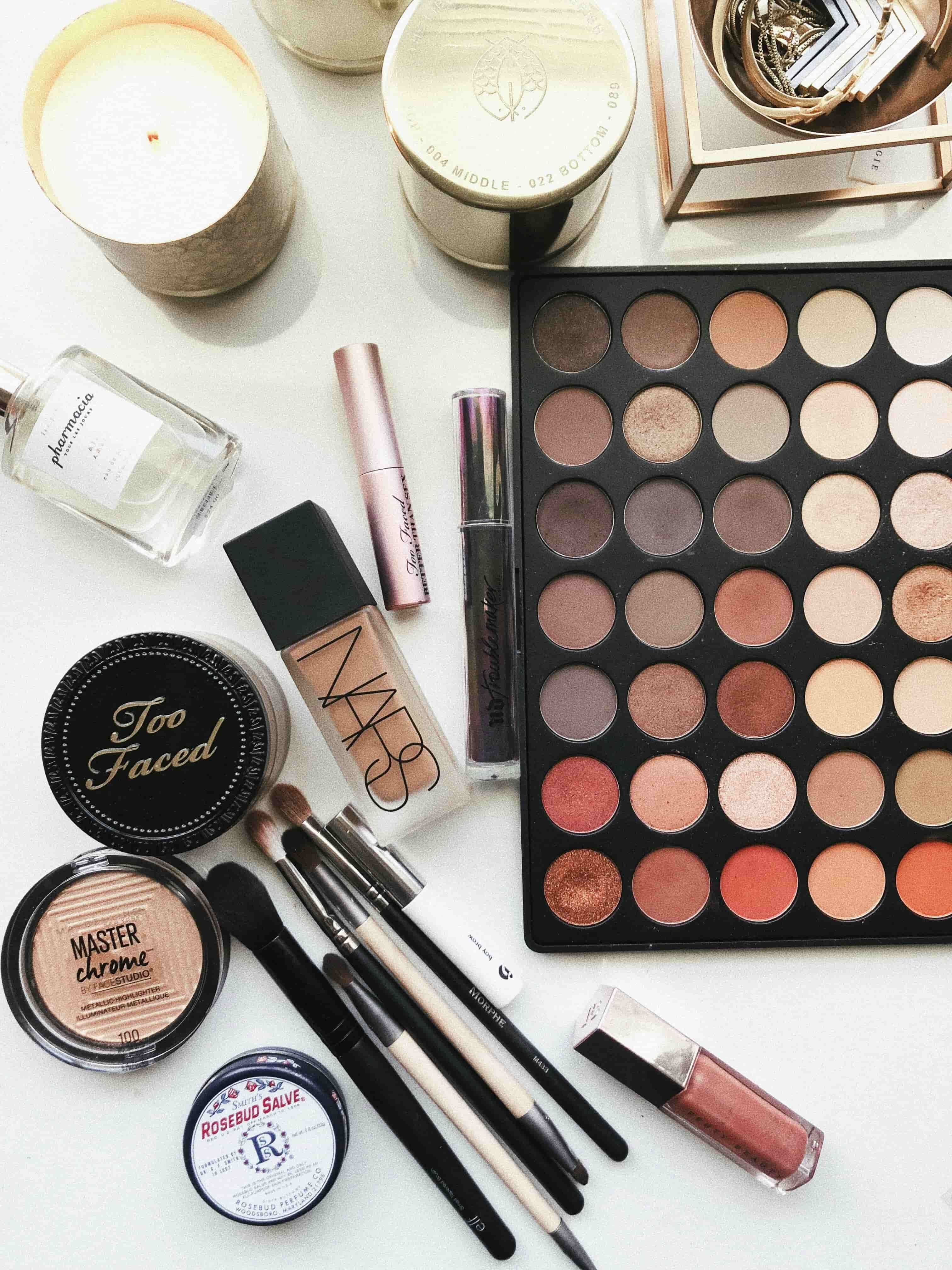 Eyeshadow palette with other make up on table