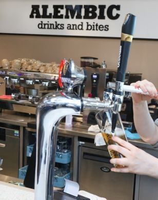 Someone pouring beer from tap