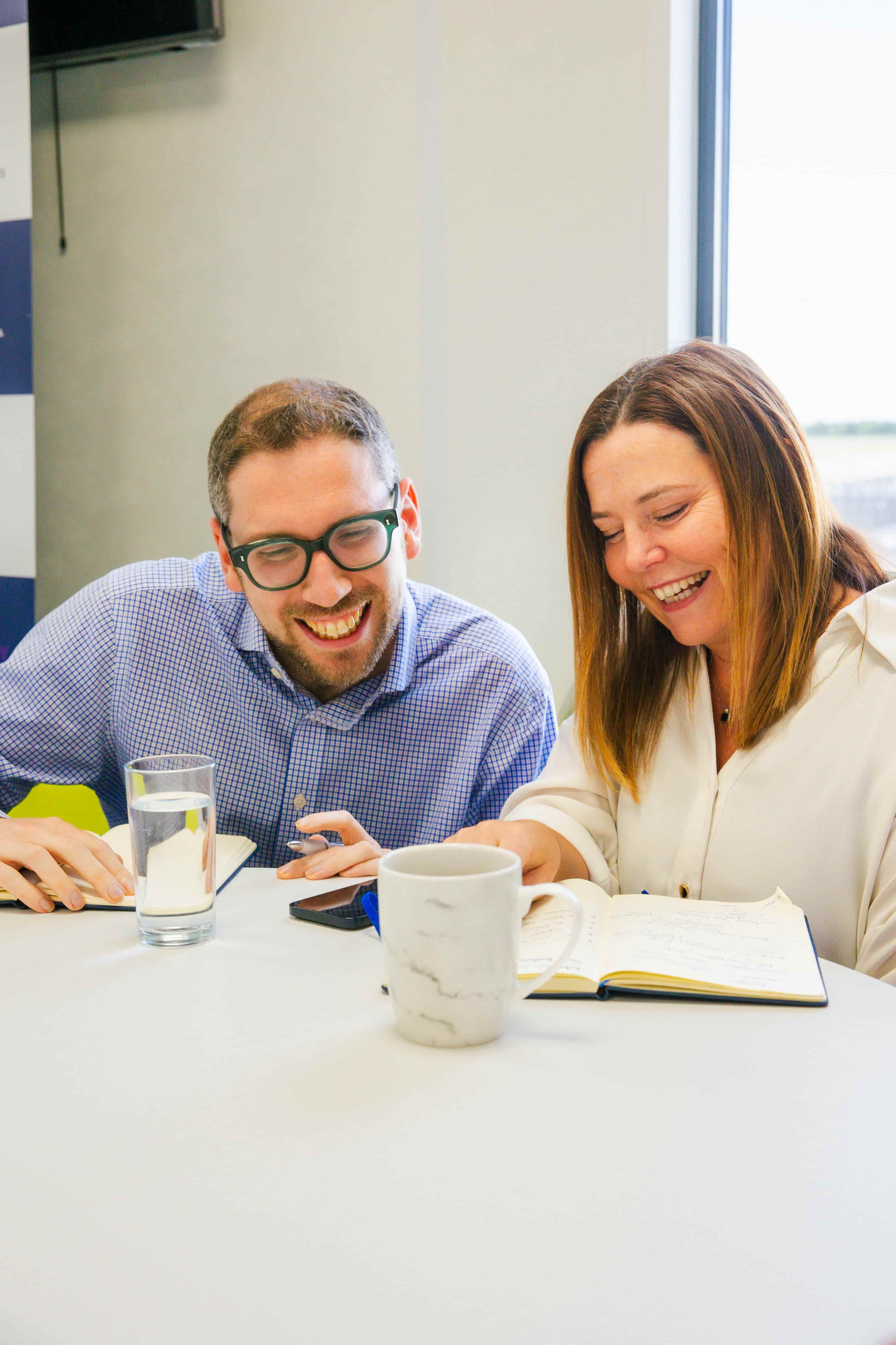 Two people looking at notebook