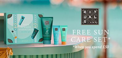 Sun care product set from Rituals displayed on a table with a "Free Sun Care Set" offer when spending £50, against a blurred summer backdrop.