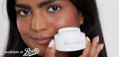 Person holding a jar of skincare labeled "byellie," with text "Available at Boots" in the corner.