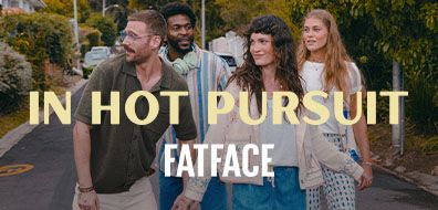Group of four people walking on a street with trees, overlaid text: "In Hot Pursuit, FatFace."
