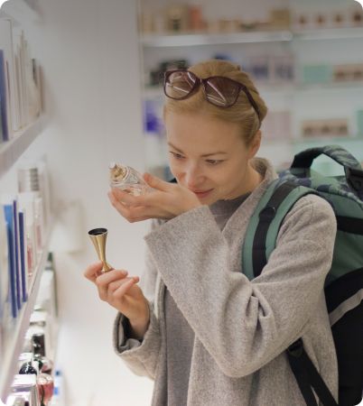 Woman smelling perfume on wrist
