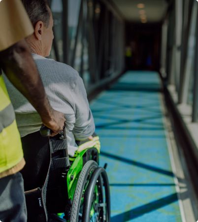 Someone pushing a man in a wheelchair