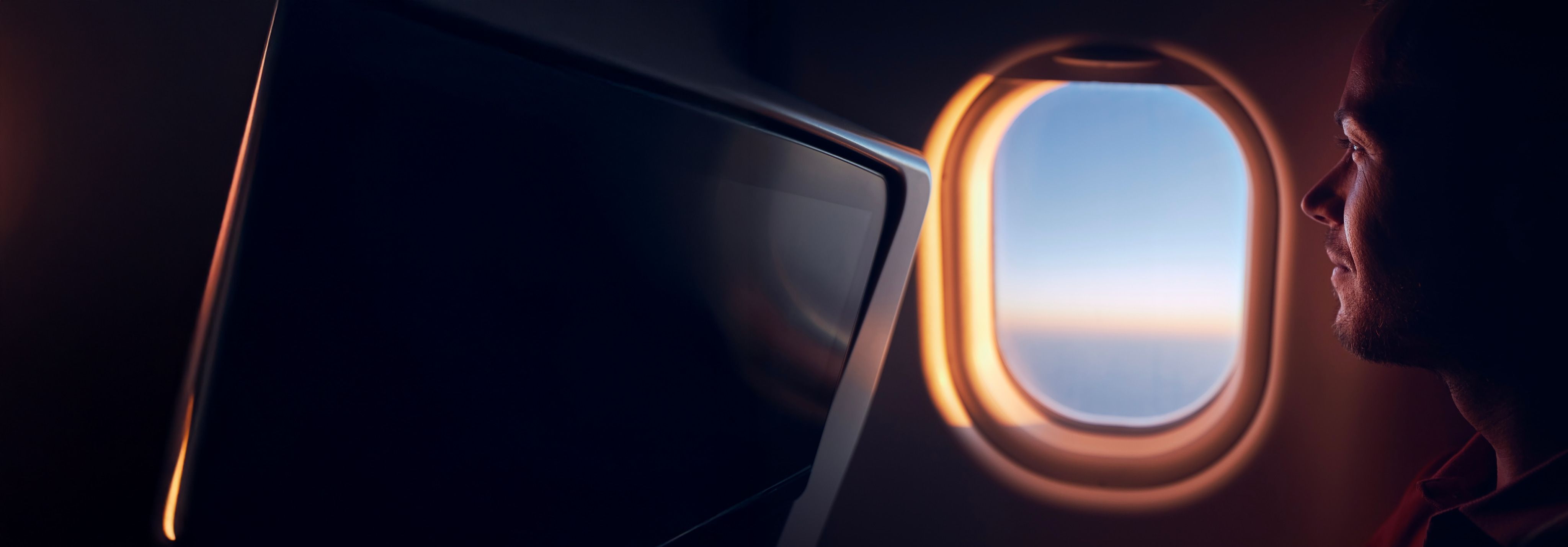Man looking out of window airplane
