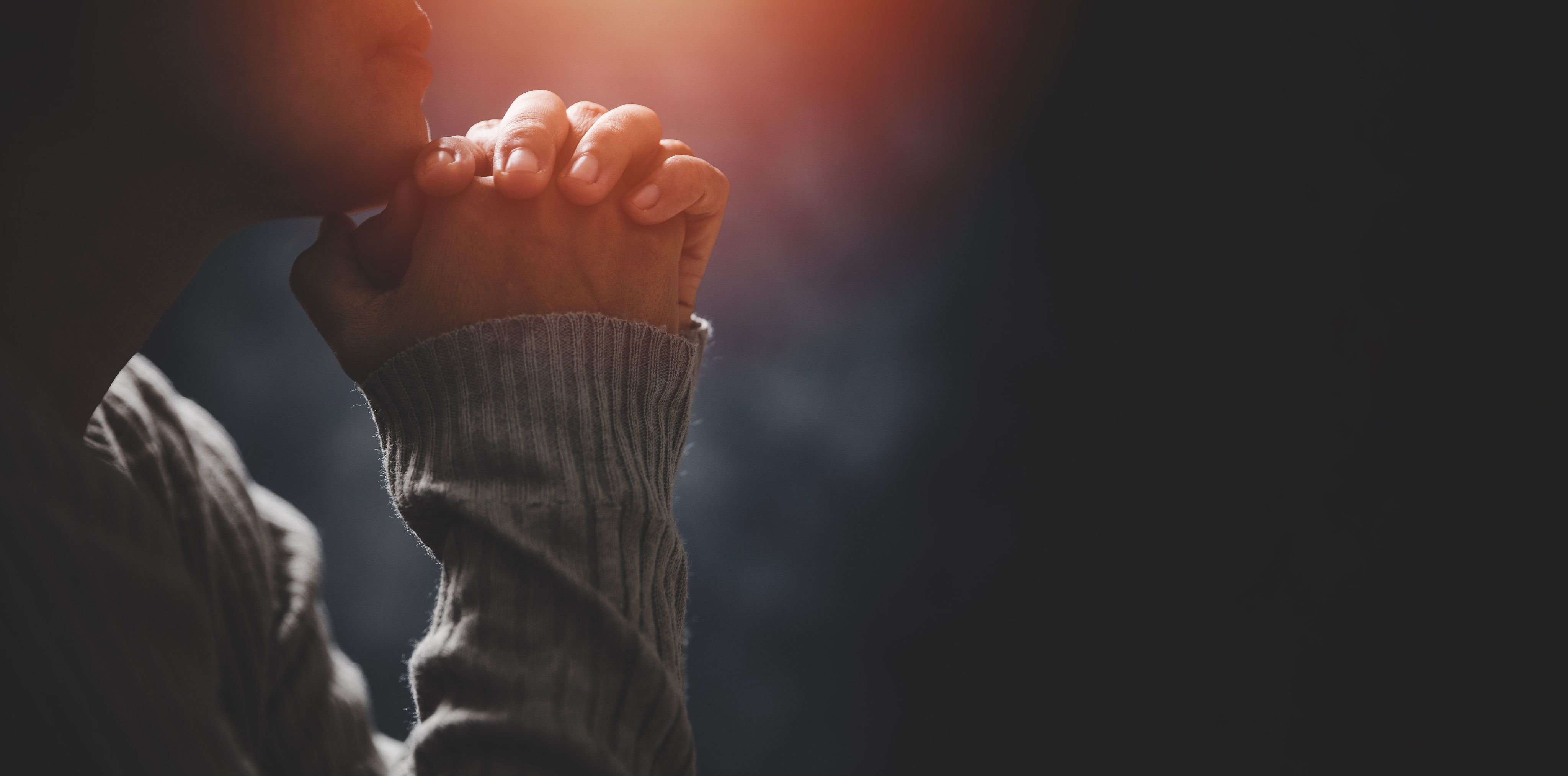 Person holding hands to pray