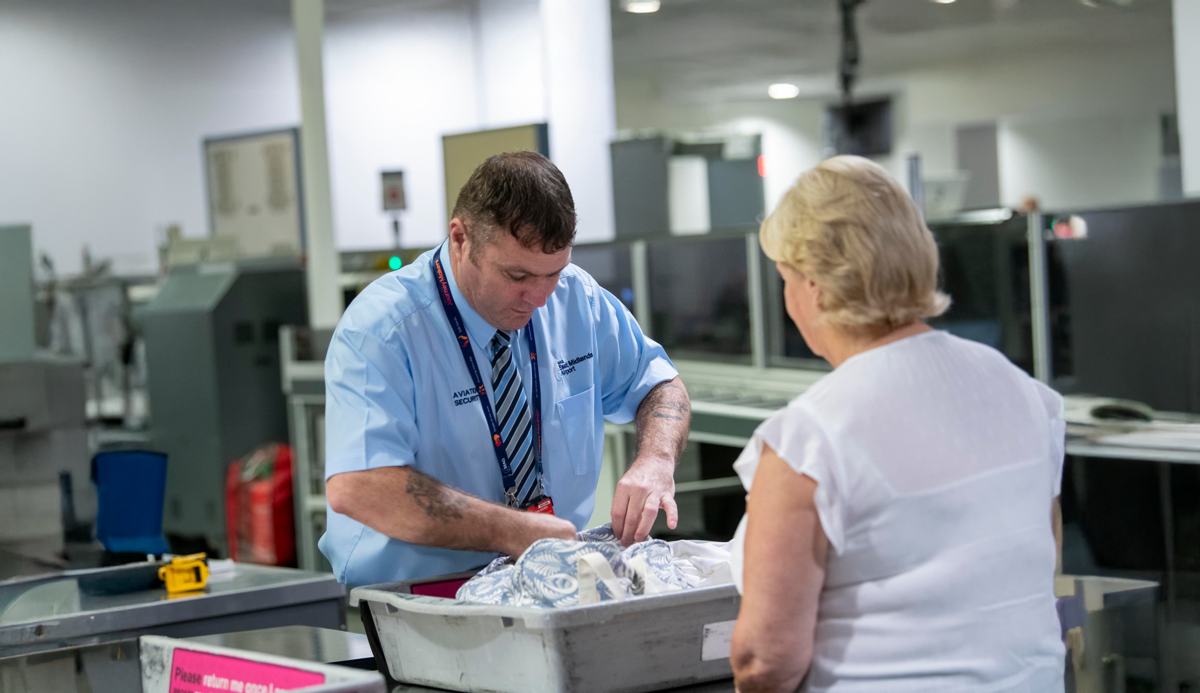 Security officer checking tray
