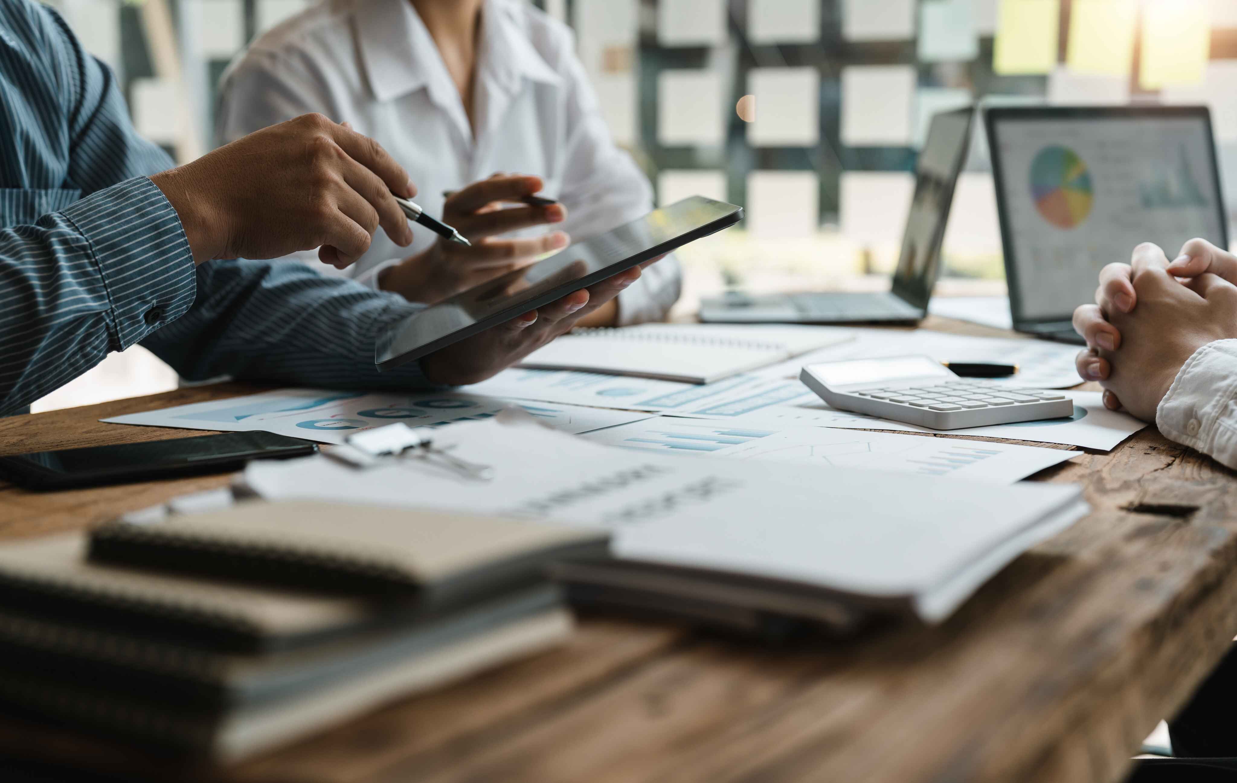 people sitting at desk with files