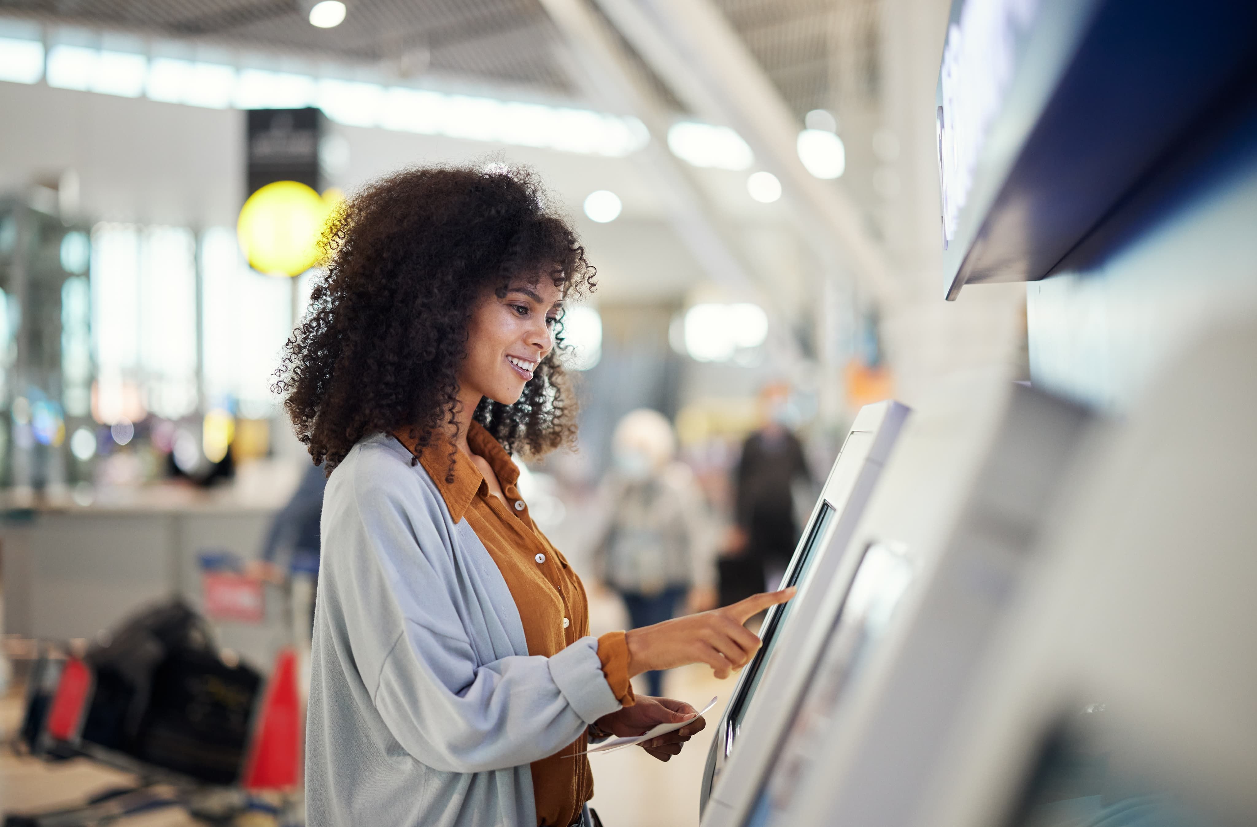 Woman smiling using touchscreen