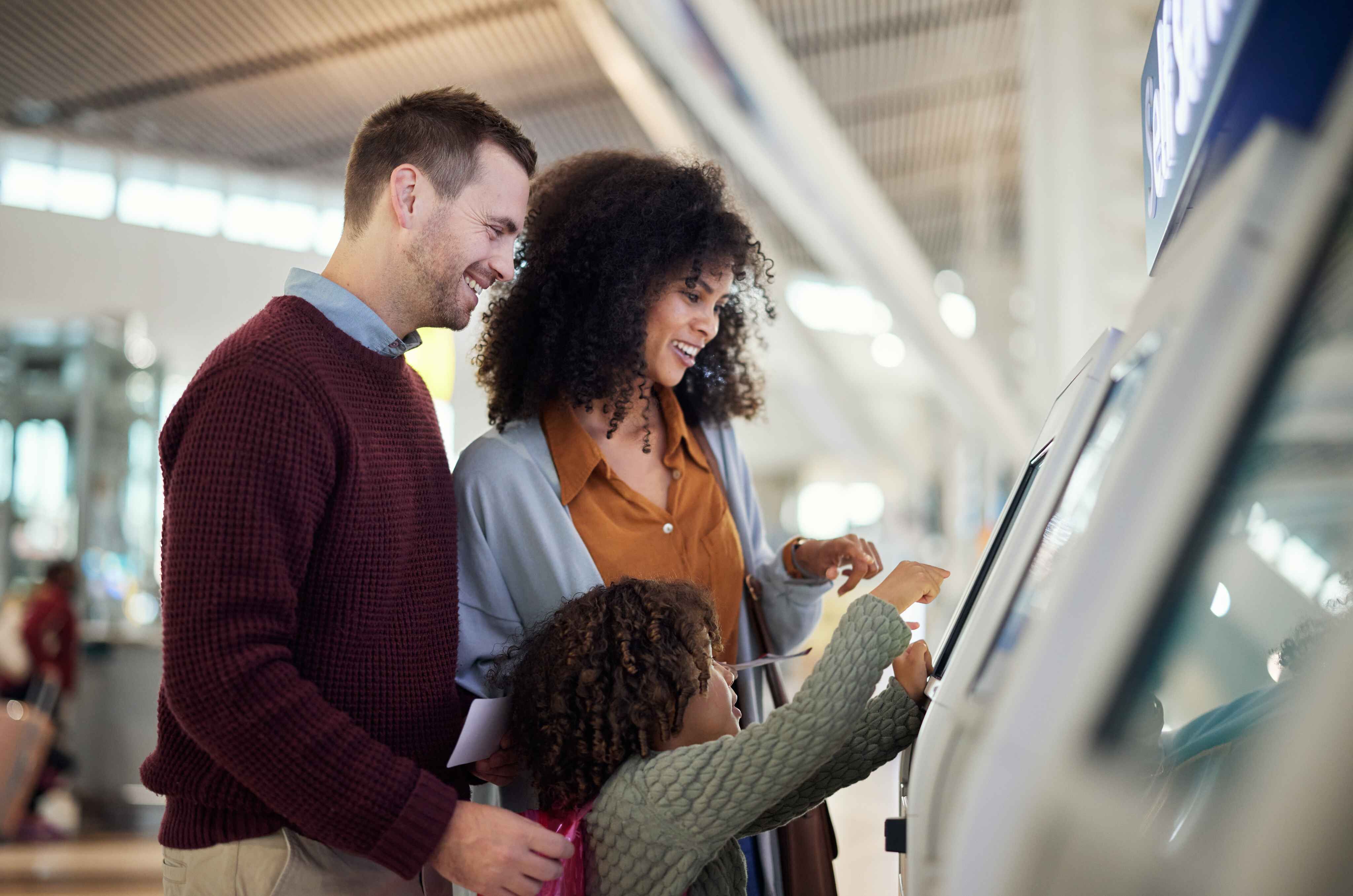 people using information kiosk at airport