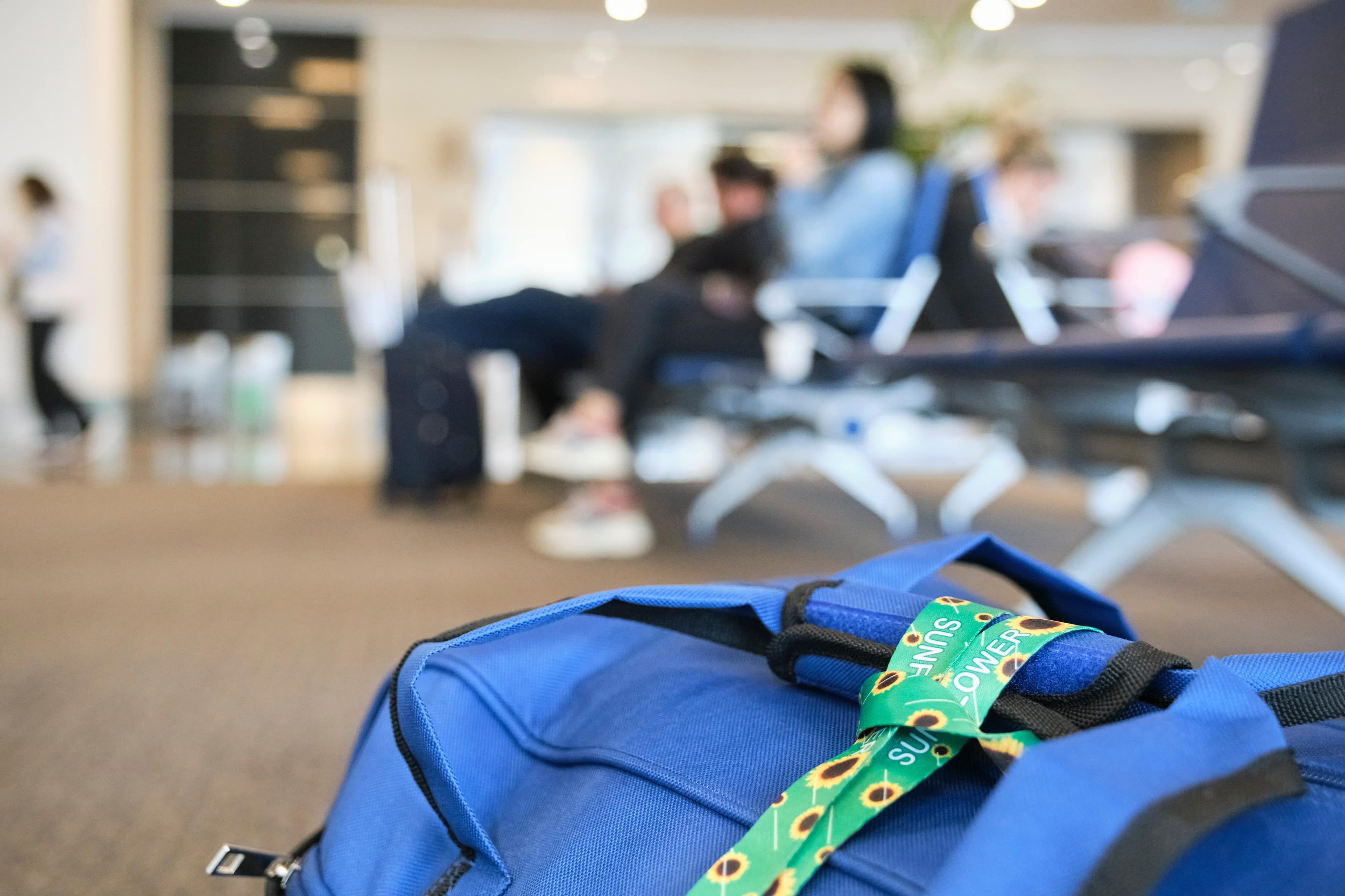 Sunflower lanyard wrapped onto blue bag handle
