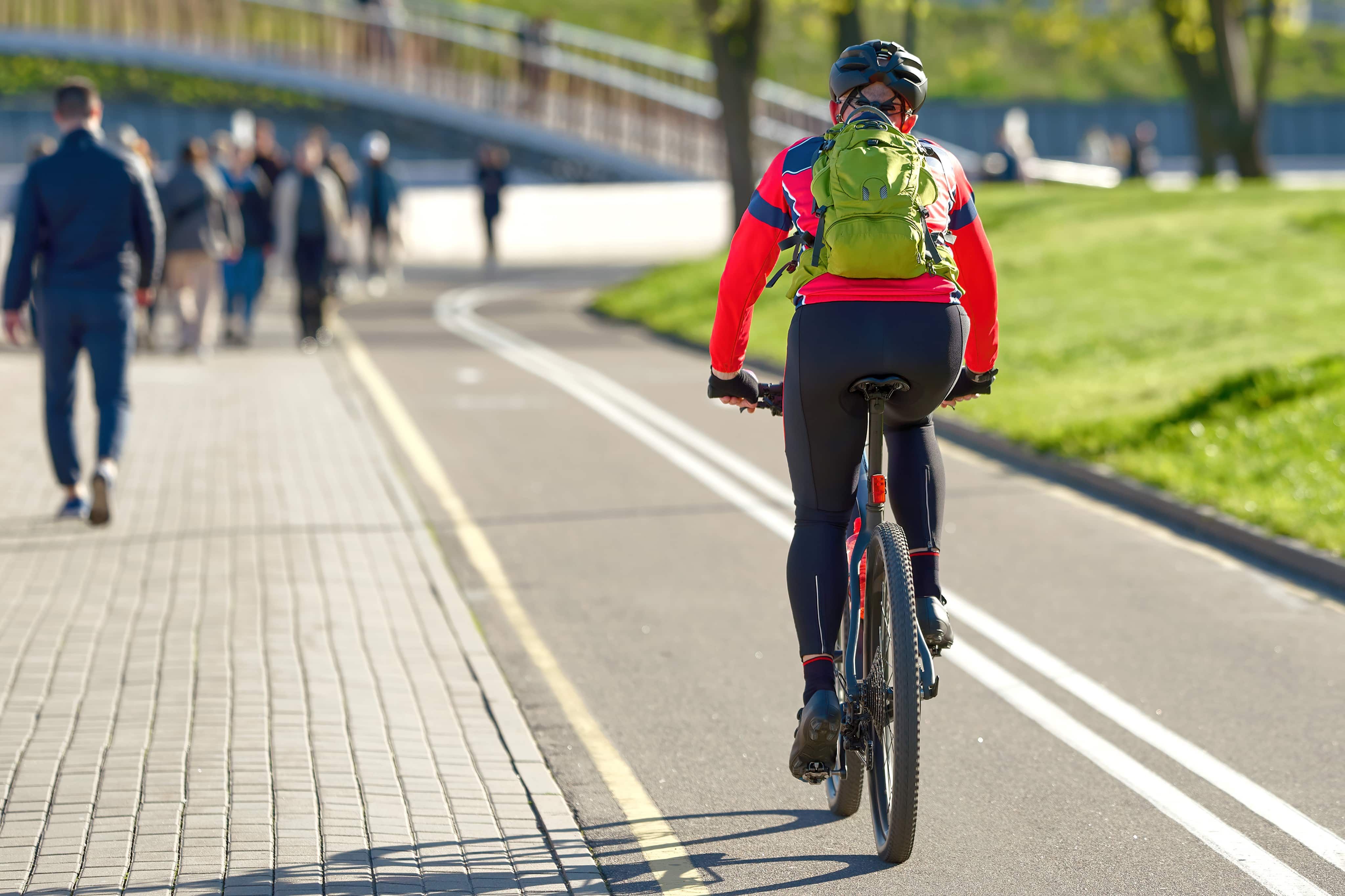 Man cycling through park
