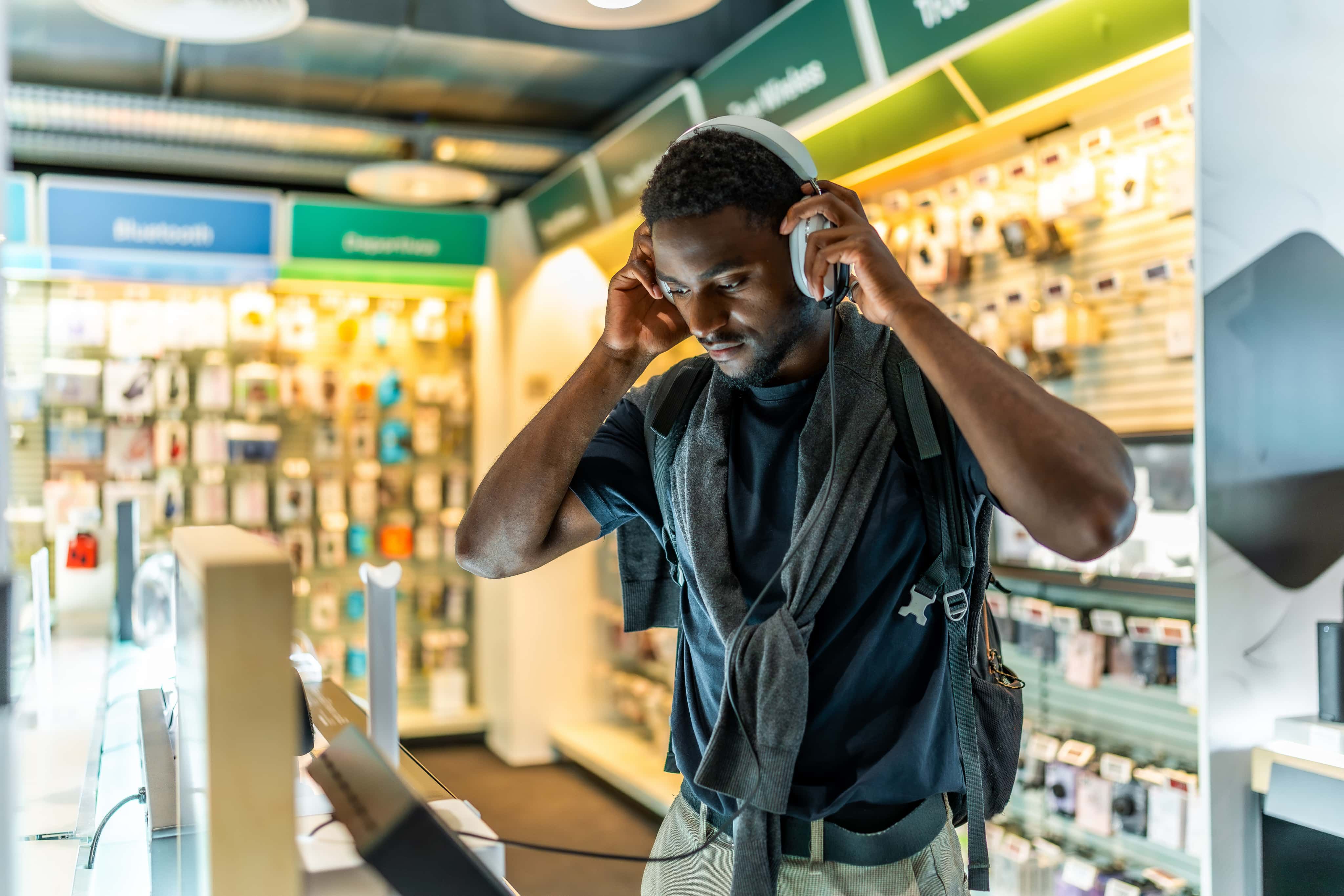 Man holding earphones on his head