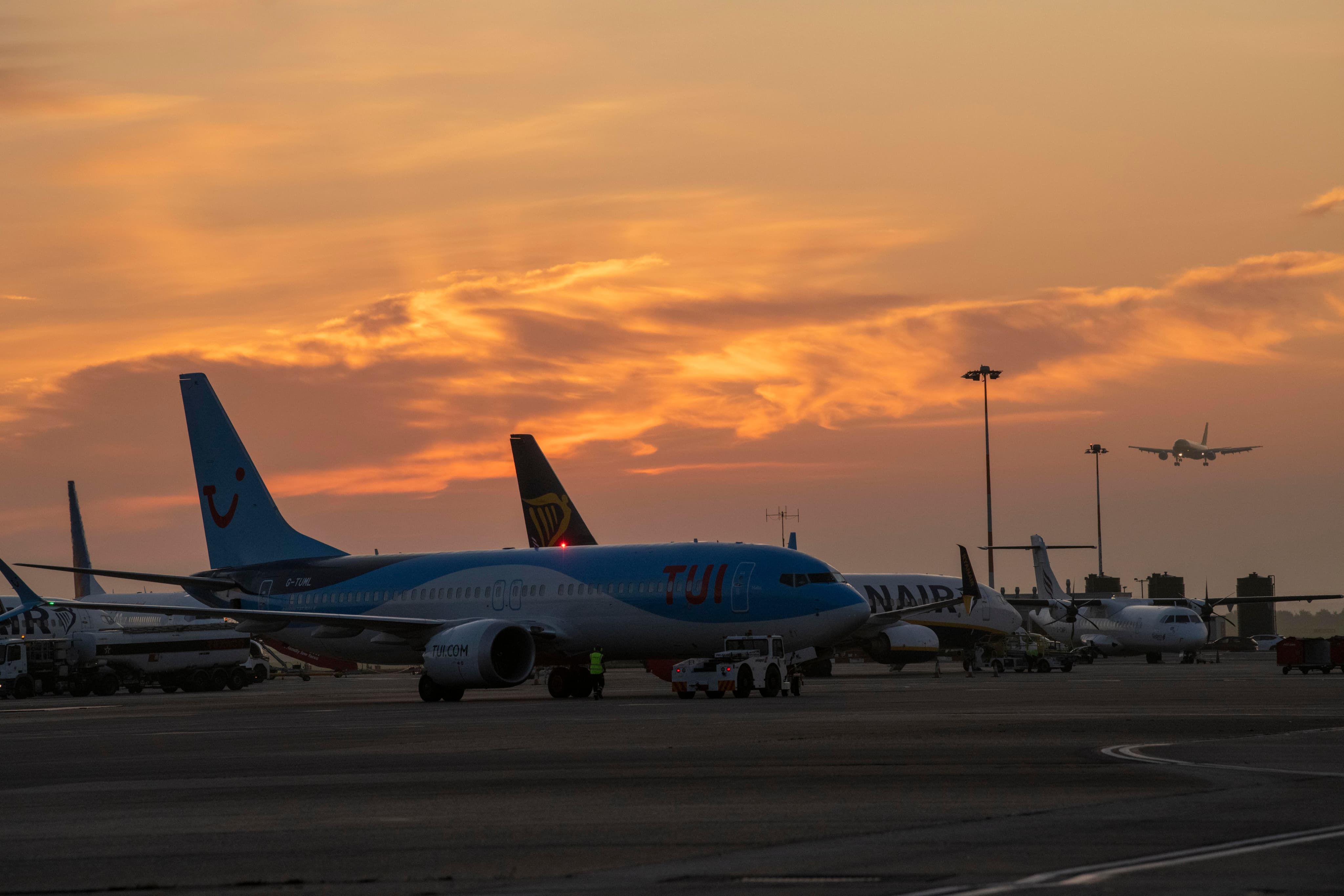 Plane with orange sunset in background