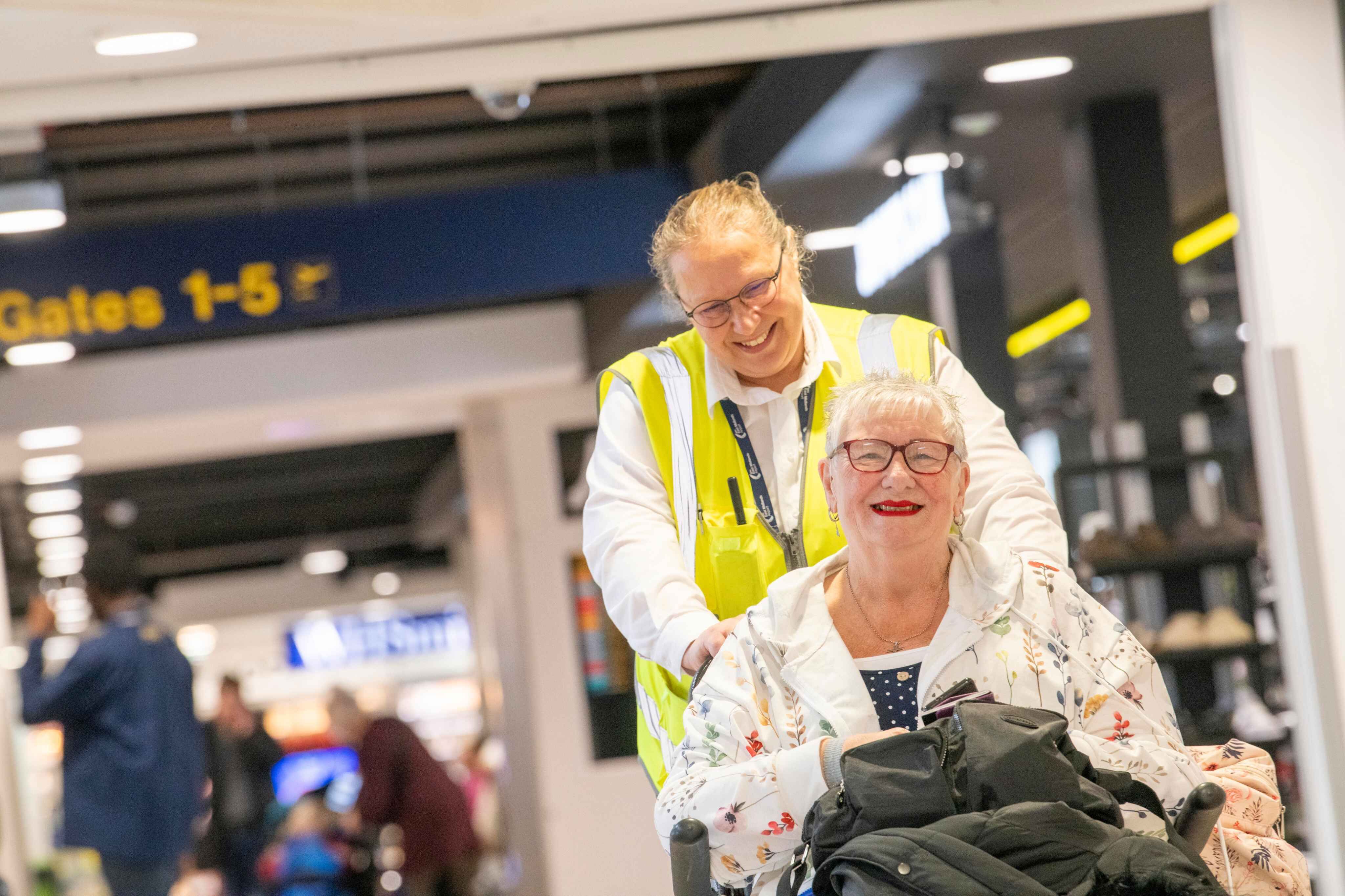 person being pushed through airiport in wheelchair