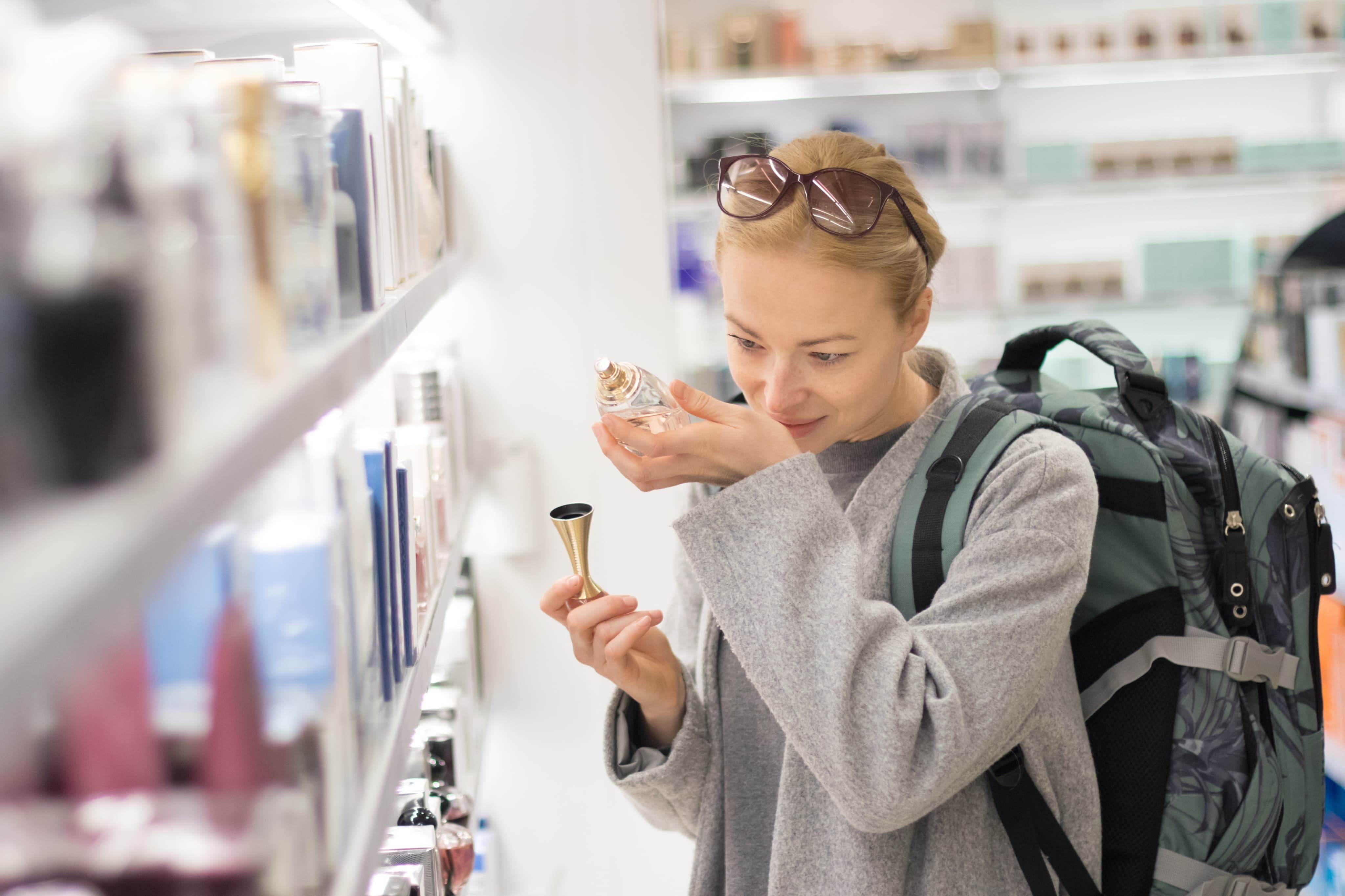 Woman smelling perfume on her wrist