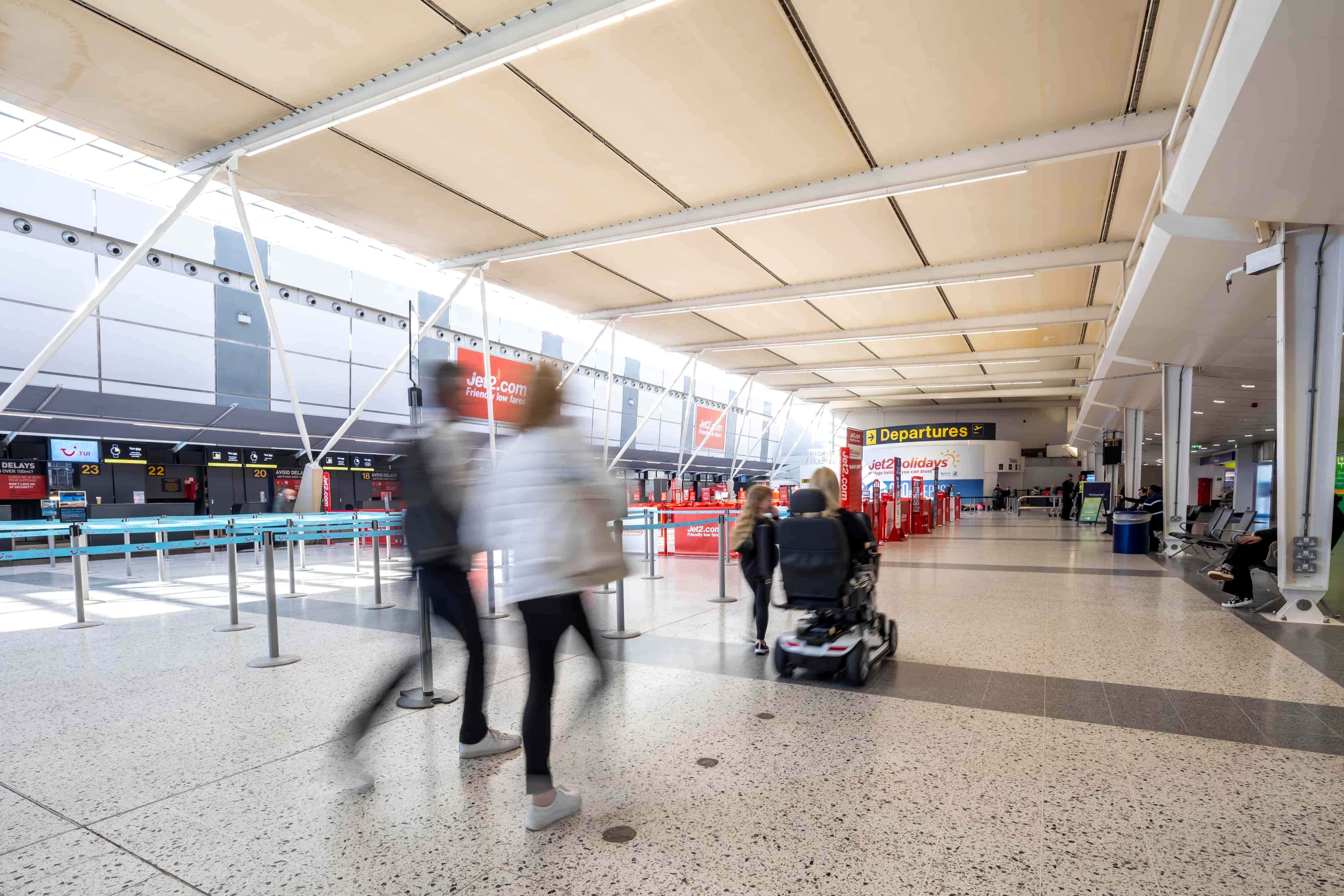 People walking through airport terminal