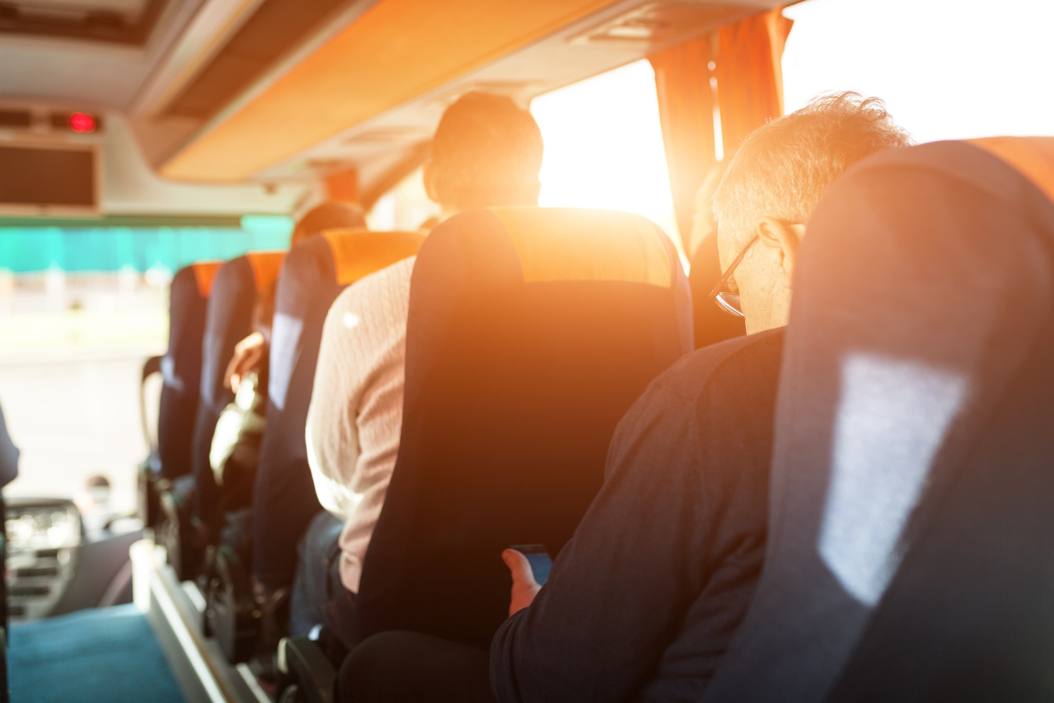 People sat on coach with sun shining through windows