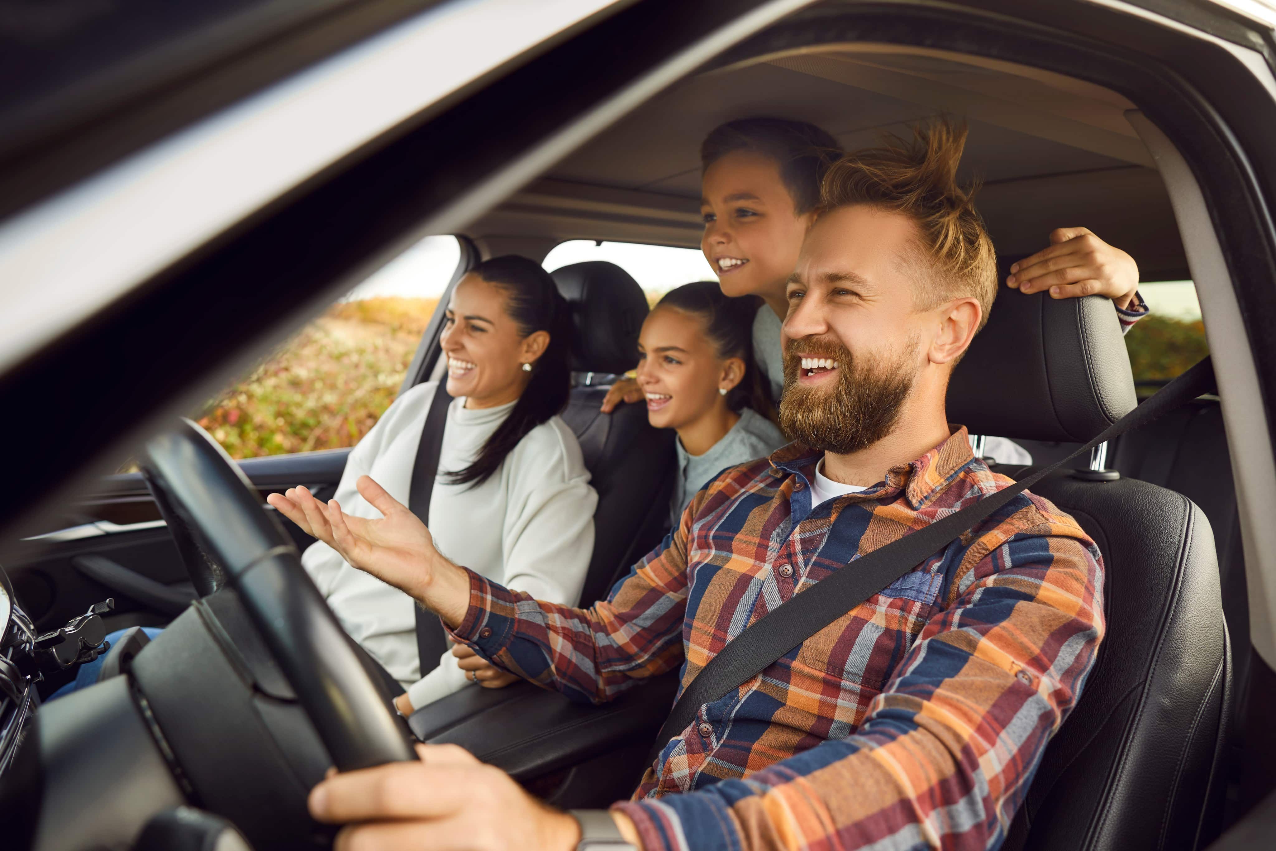 Family sat in car laughing