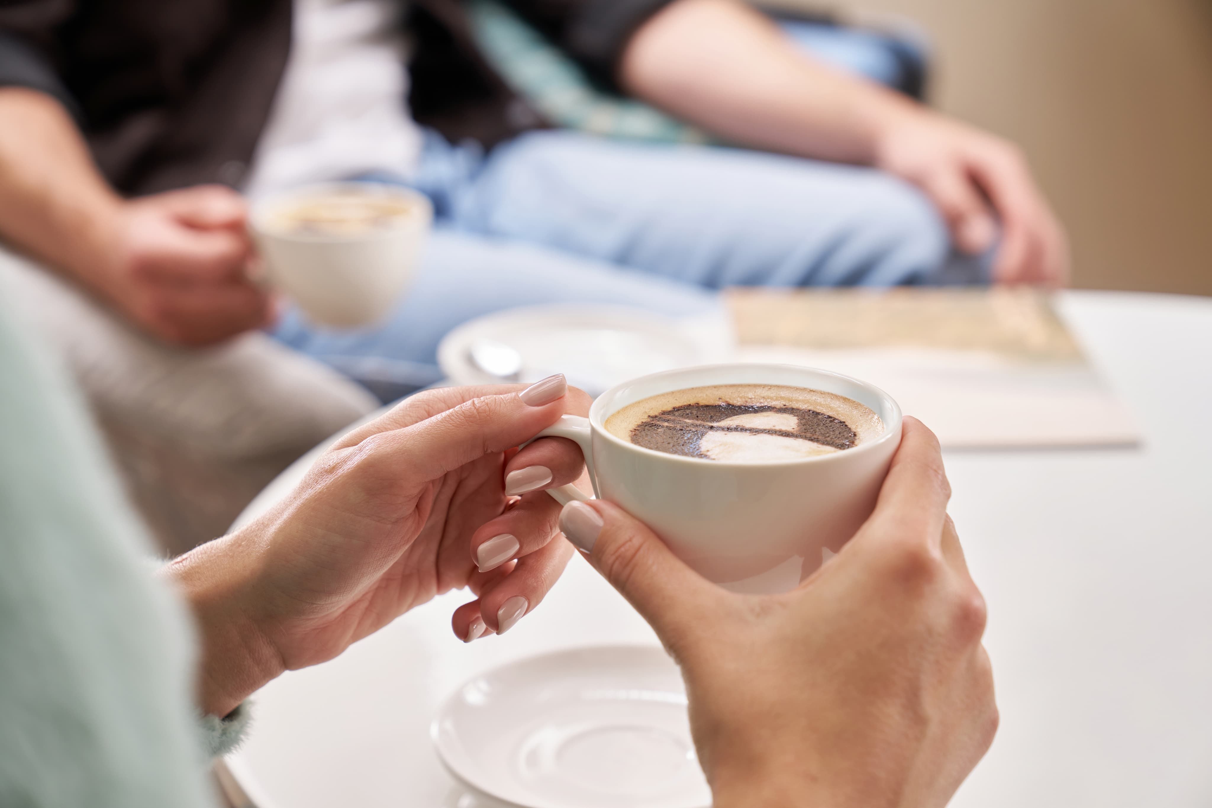 People holding cups of coffee