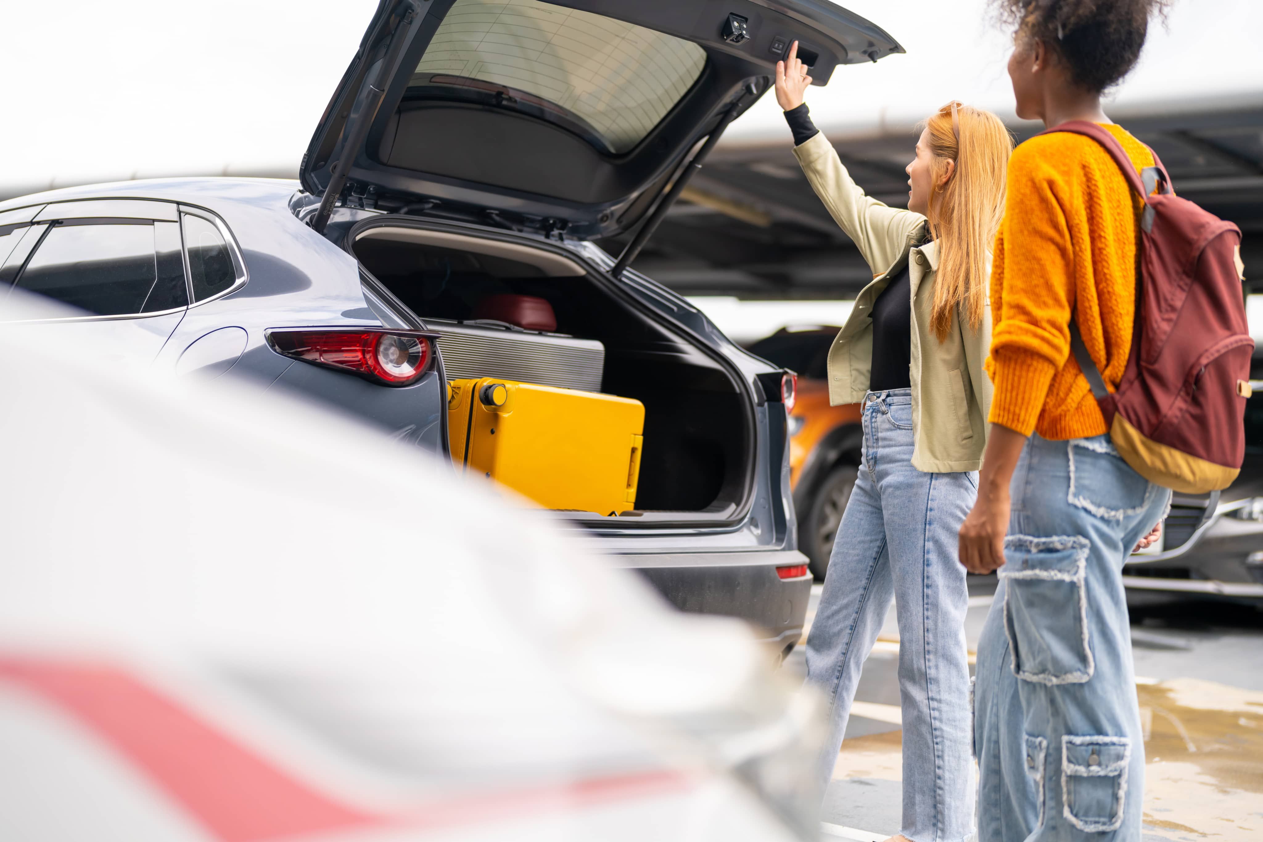 Woman shutting car boot