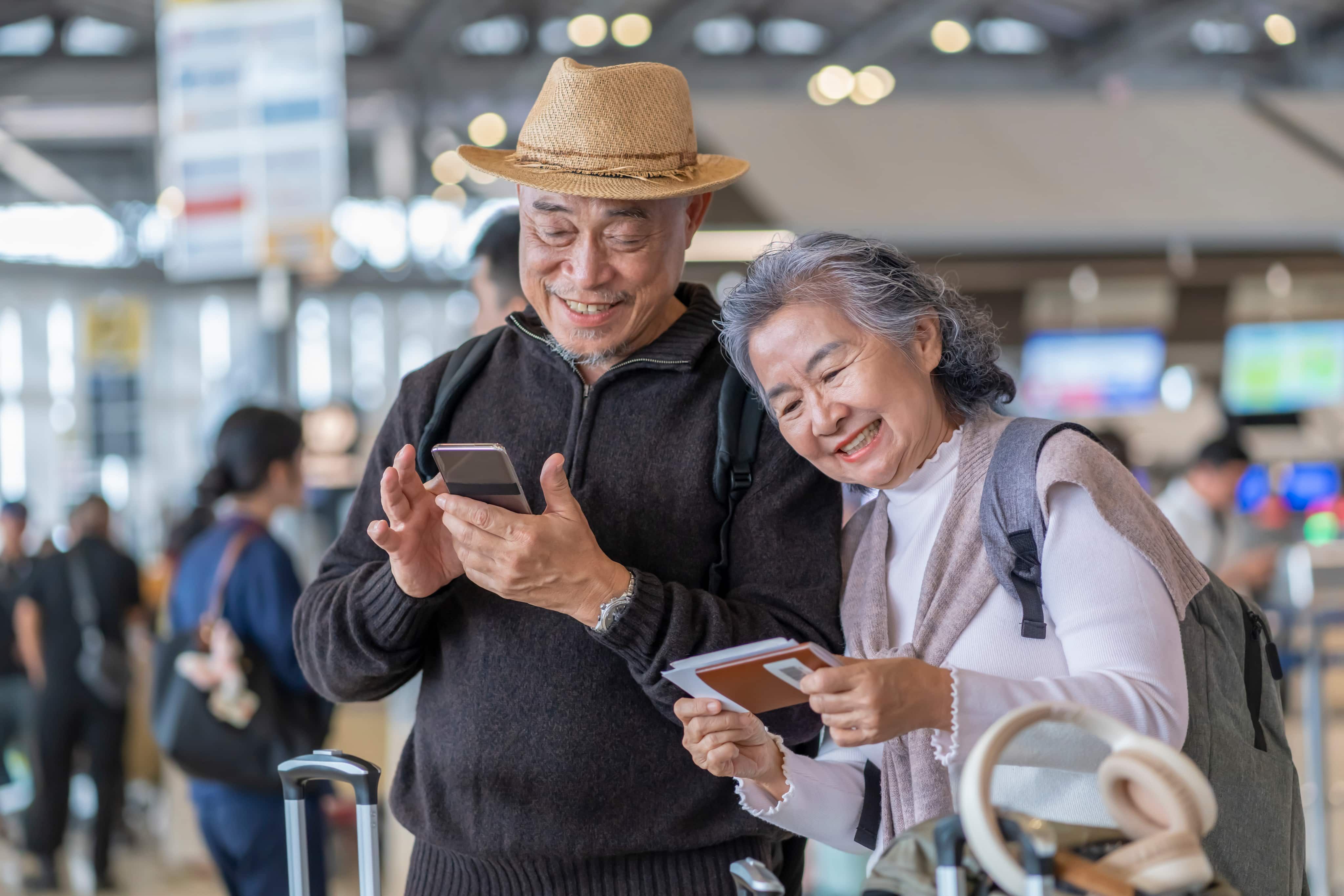 Couple looking at phone and passport