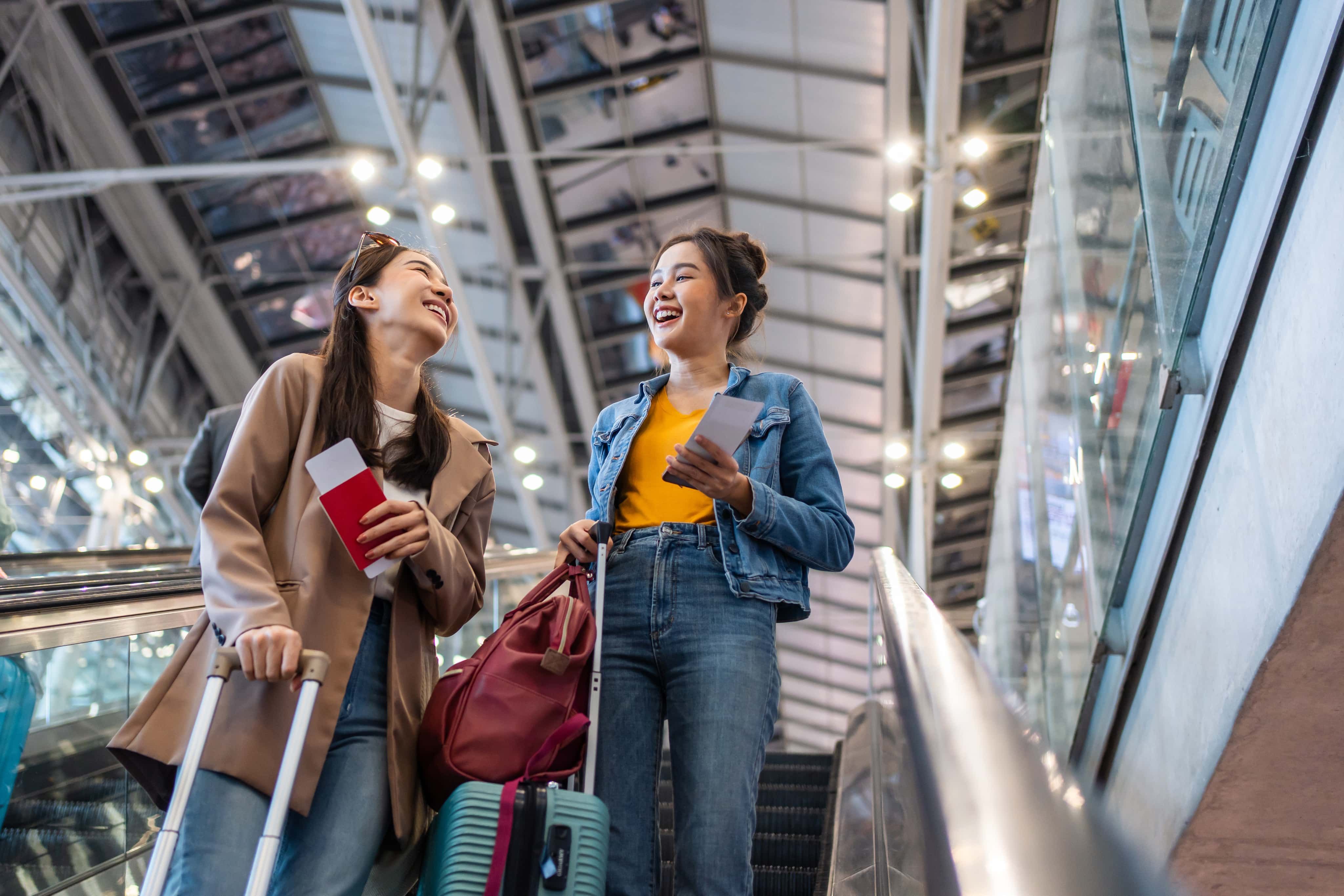 Girls laughing going down escalator