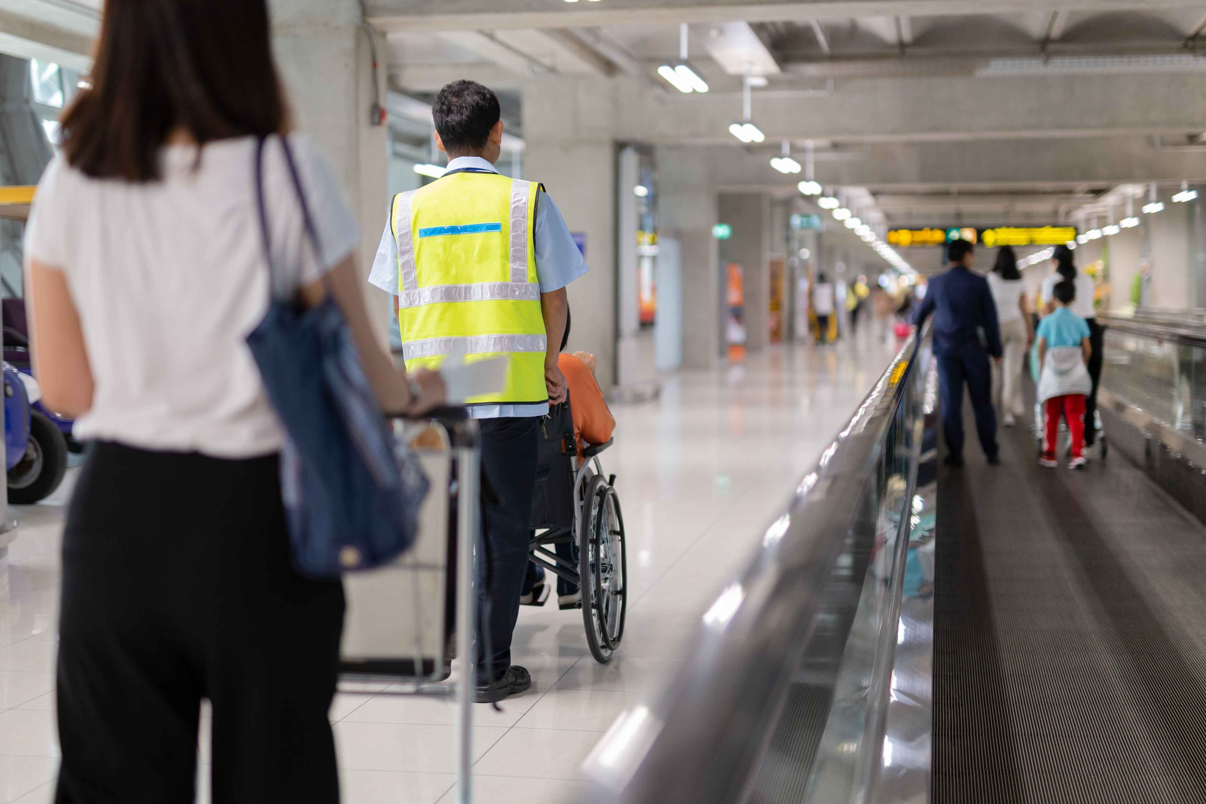 person being pushed through airiport in wheelchair
