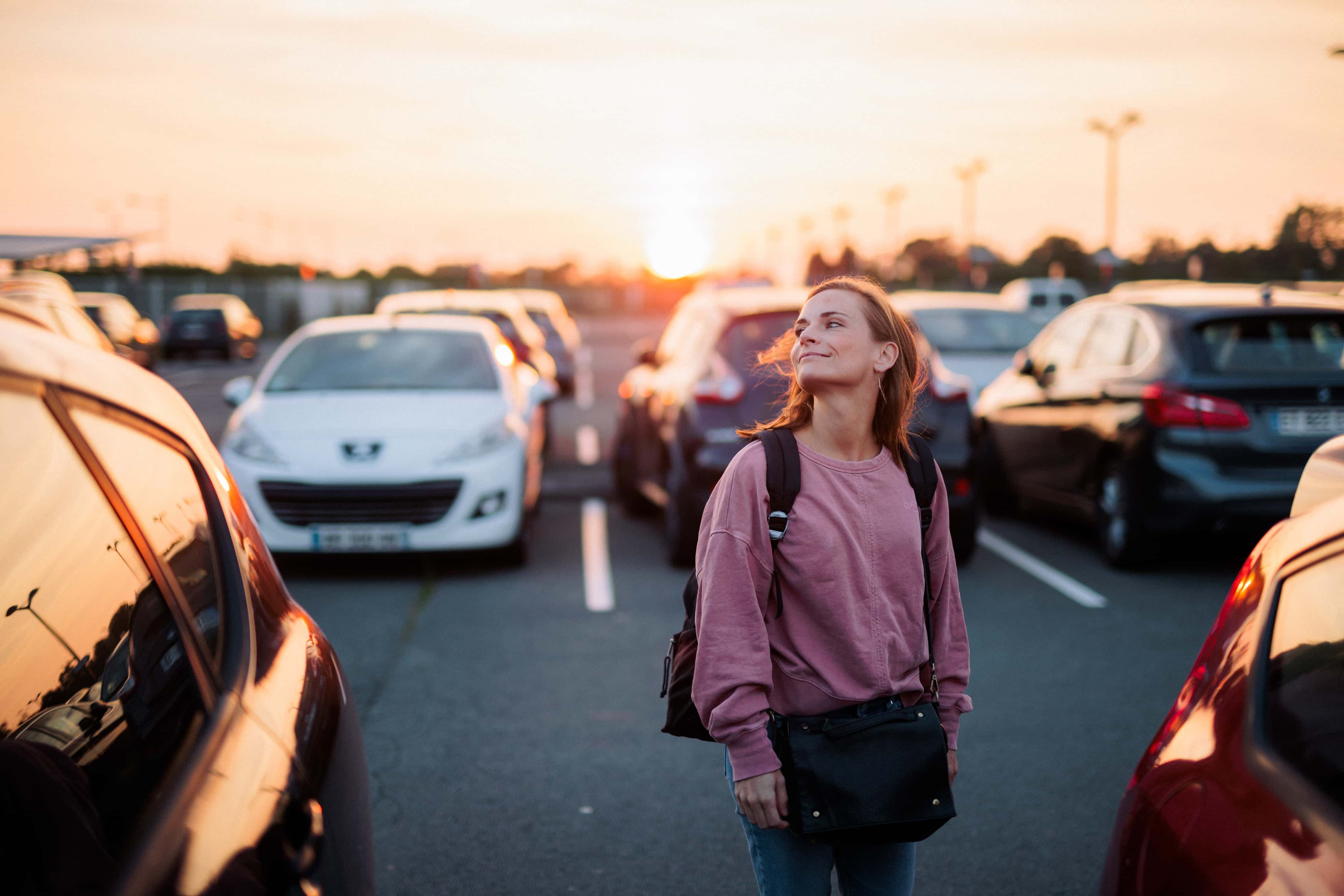 Woman smiling in car park