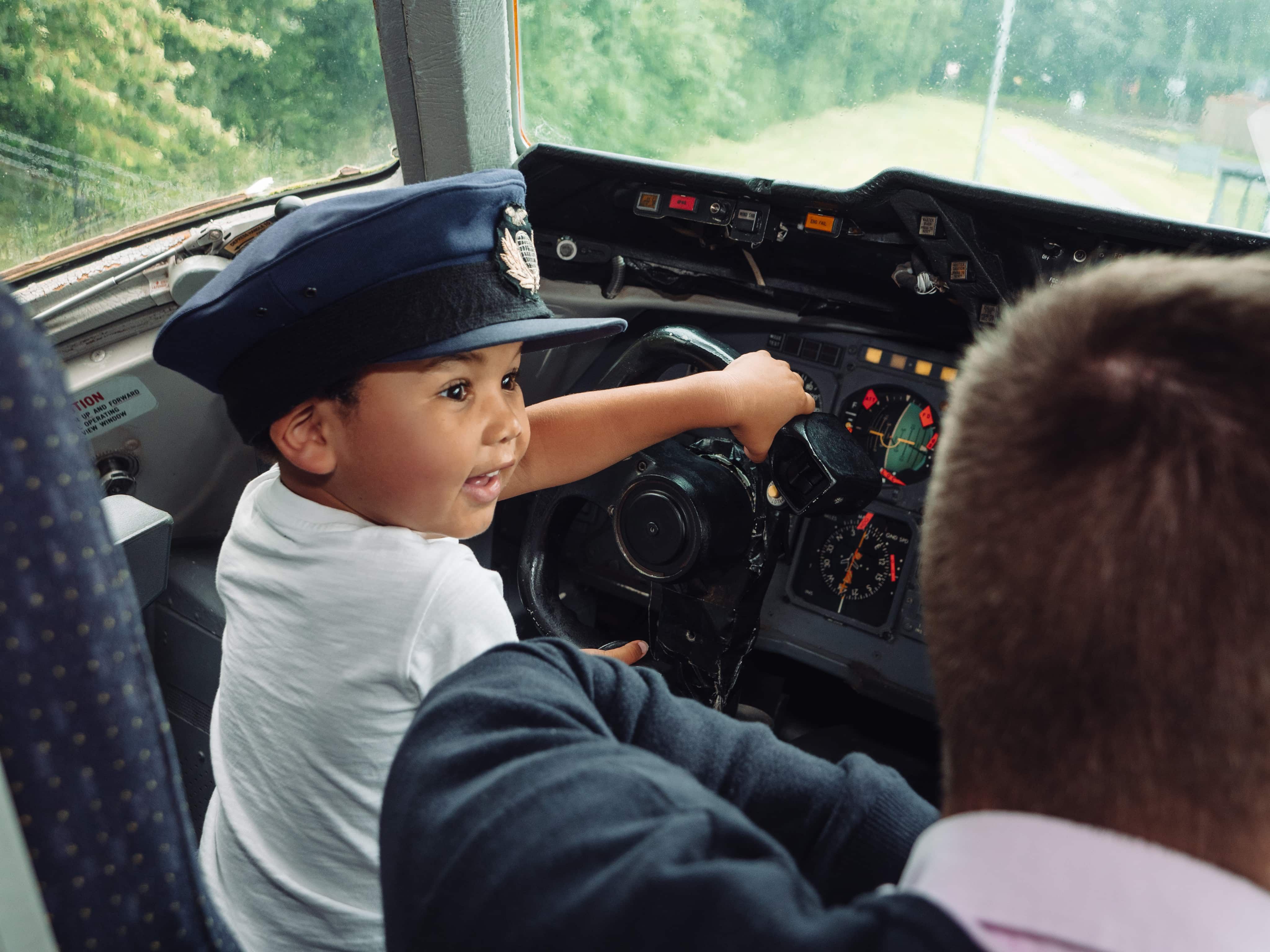 Little boy in pilot seat of plane