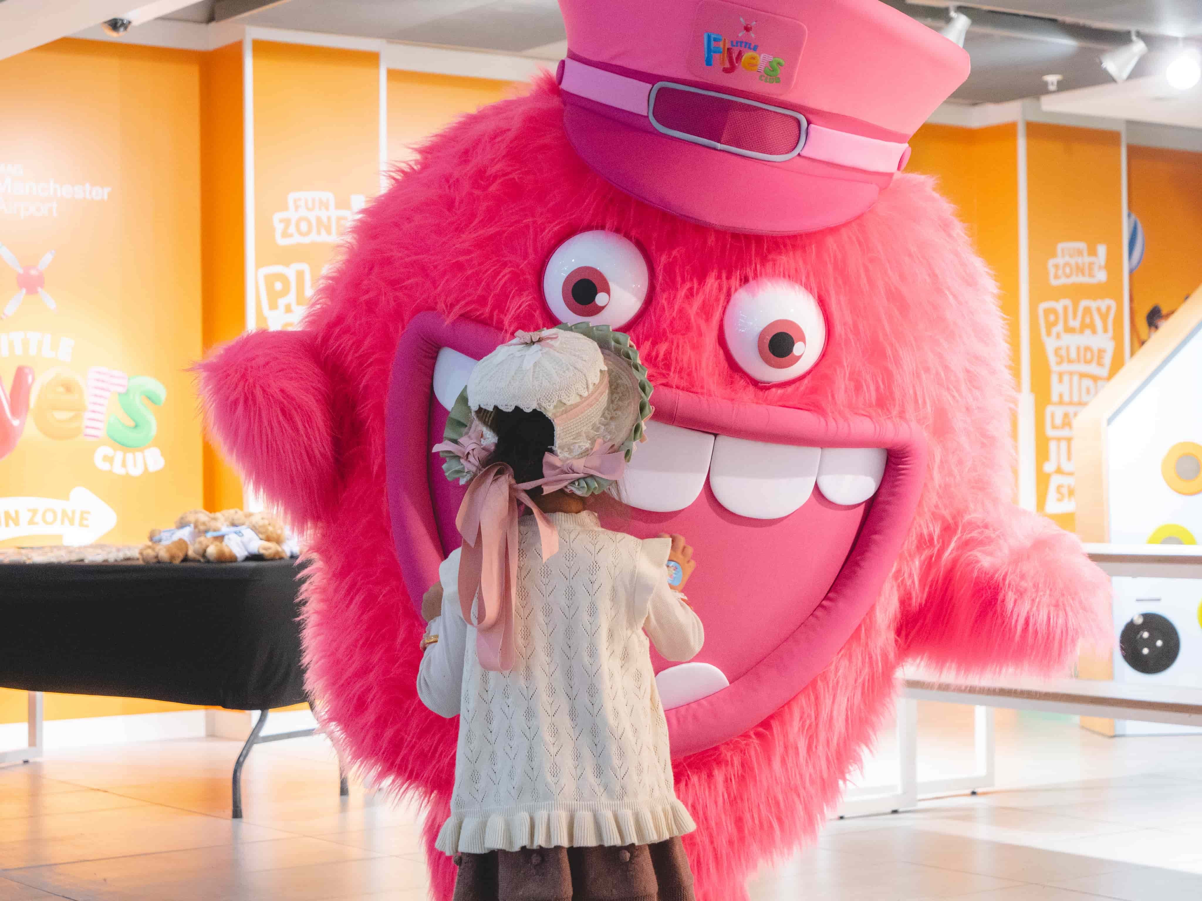 Little girl meeting bit furry character