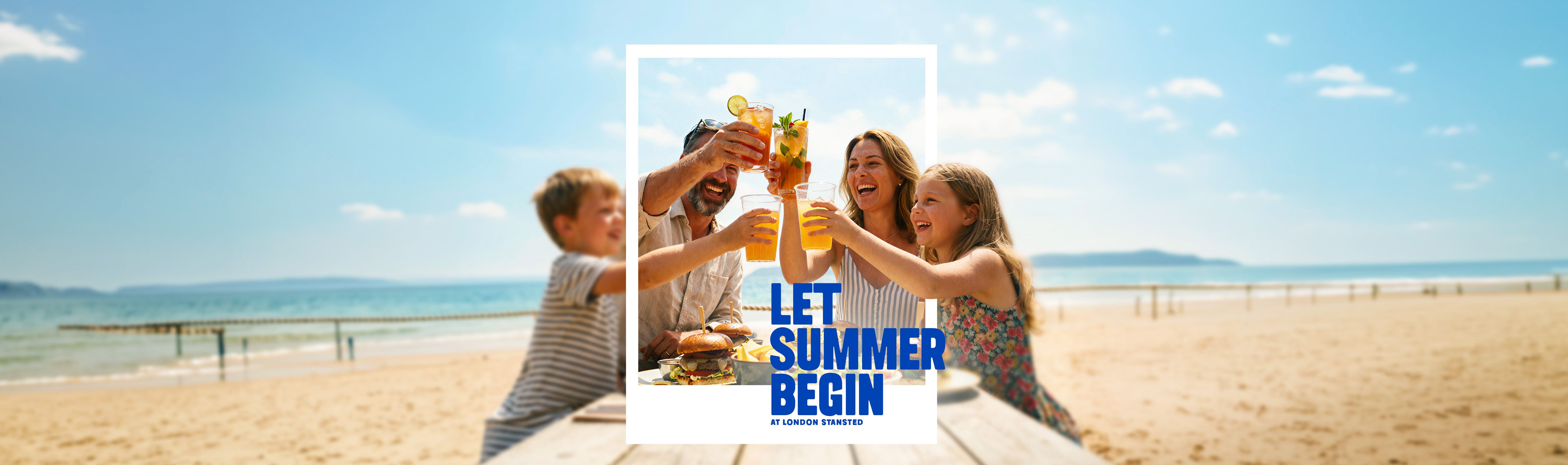 Family toasting with drinks at a beachside picnic table under a sunny sky, with text "Let Summer Begin" overlaid.