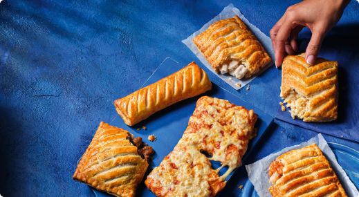 Various pasty's on blue background from Greggs