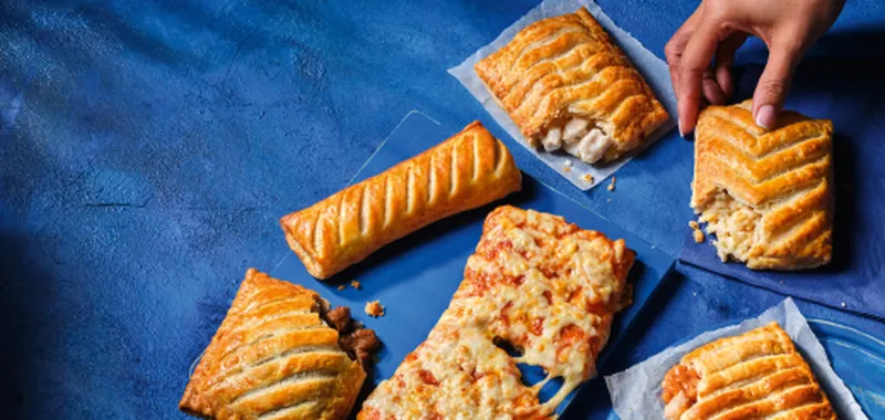 Various pasty's on blue background from Greggs